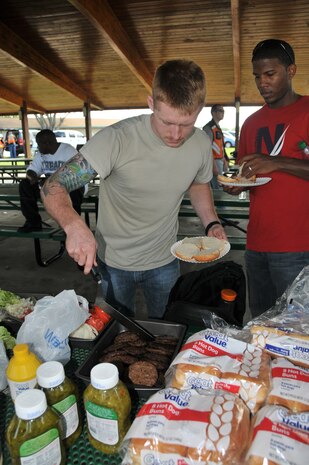 Senior Airman Luke Harshman prepares a burger during the 2012 Joint Base Charleston Motorcycle Safety Event, at Short Stay, the Navy’s Outdoor Recreation Area March 23. The event provided motorcyclists with information about safe riding, motorcycle laws in South Carolina, military regulations and proper riding equipment.  Harshman is from the 437th Operations Support Squadron. (U.S. Air Force photo/Airman 1st Class Jared Trimarchi)
