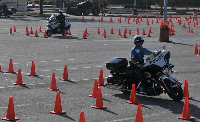 A police officer shows off his maneuvering skills March 23 during the Seventh Annual Palmetto Police Motorcycle Rodeo. The rodeo was one of the stops during the 2012 Joint Base Charleston Motorcycle Safety Event. The event provided motorcyclists with information about safe riding, motorcycle laws in South Carolina, military regulations and proper riding equipment.  (U.S. Air Force photo/Airman 1st Class Jared Trimarchi)
