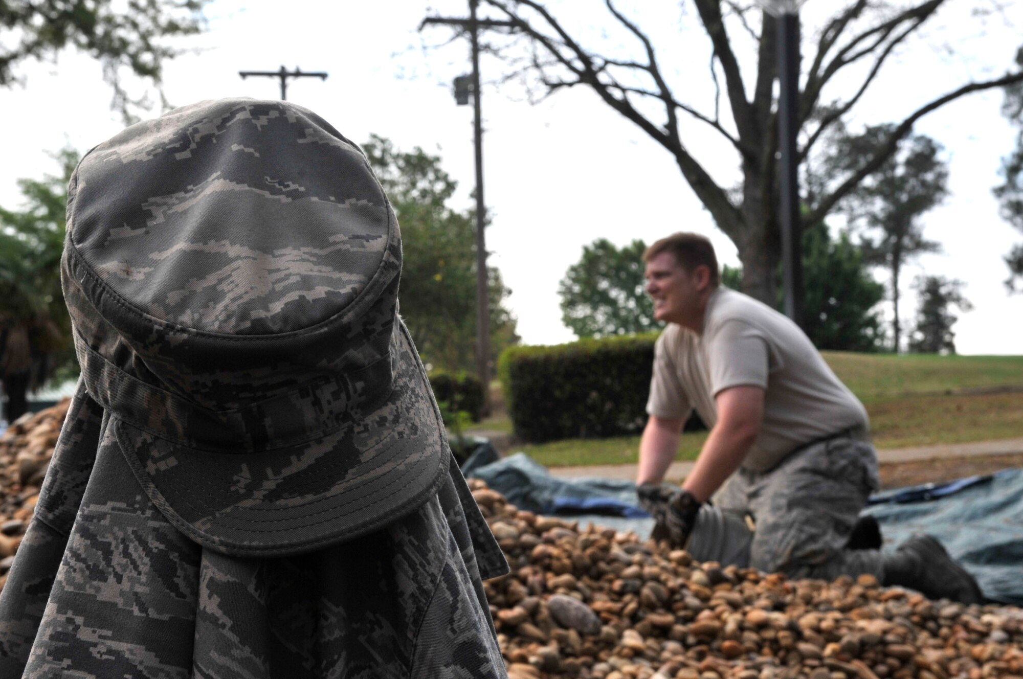 U.S. Air Force Master Sgt. Joey Nadeau, Logistics Readiness Squadron, Non Commissioned Officer in charge fills a bucket with rocks at Carolina Lakes Golf Course at Shaw Air Force Base, S.C., March 24, 2012. Nadeau and other Airmen were helping to lay rocks at the front of Carolina Lakes Golf Course building.(U.S. Air Force photo by Airman Nicole Sikorski/Released)