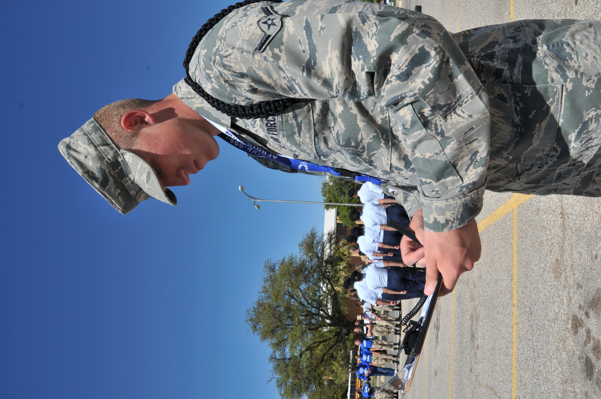 SAN ANGELO, Texas – Airman Dylan Ridener, 316th Training Squadron student  and guest judge scores a Junior Reserve Officers’ Training Corps drill team during a JROTC drill competition meet at Angelo State University March 24. The event was organized by Air Force Reserve Officers’ Training Corps Detachment 847 members. (U.S. Air Force photo/ Staff Sgt. Tong Duong)
