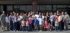 437th Maintenance Group spouses and family members pose for a group photo after touring the 437th MXG facilities courtesy of Col. James Clavenna, 437th MXG commander March 2. The 437th MXG is responsible for maintaining 55 C-17 Globemaster III aircraft valued at $11.1 billion through a workforce of four squadrons comprised of 1,800 military and civilian personnel. (U.S. Air Force photo/Staff Sgt. Shandelle Laurine)