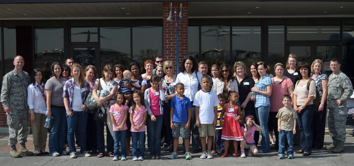 437th Maintenance Group spouses and family members pose for a group photo after touring the 437th MXG facilities courtesy of Col. James Clavenna, 437th MXG commander March 2. The 437th MXG is responsible for maintaining 55 C-17 Globemaster III aircraft valued at $11.1 billion through a workforce of four squadrons comprised of 1,800 military and civilian personnel. (U.S. Air Force photo/Staff Sgt. Shandelle Laurine)