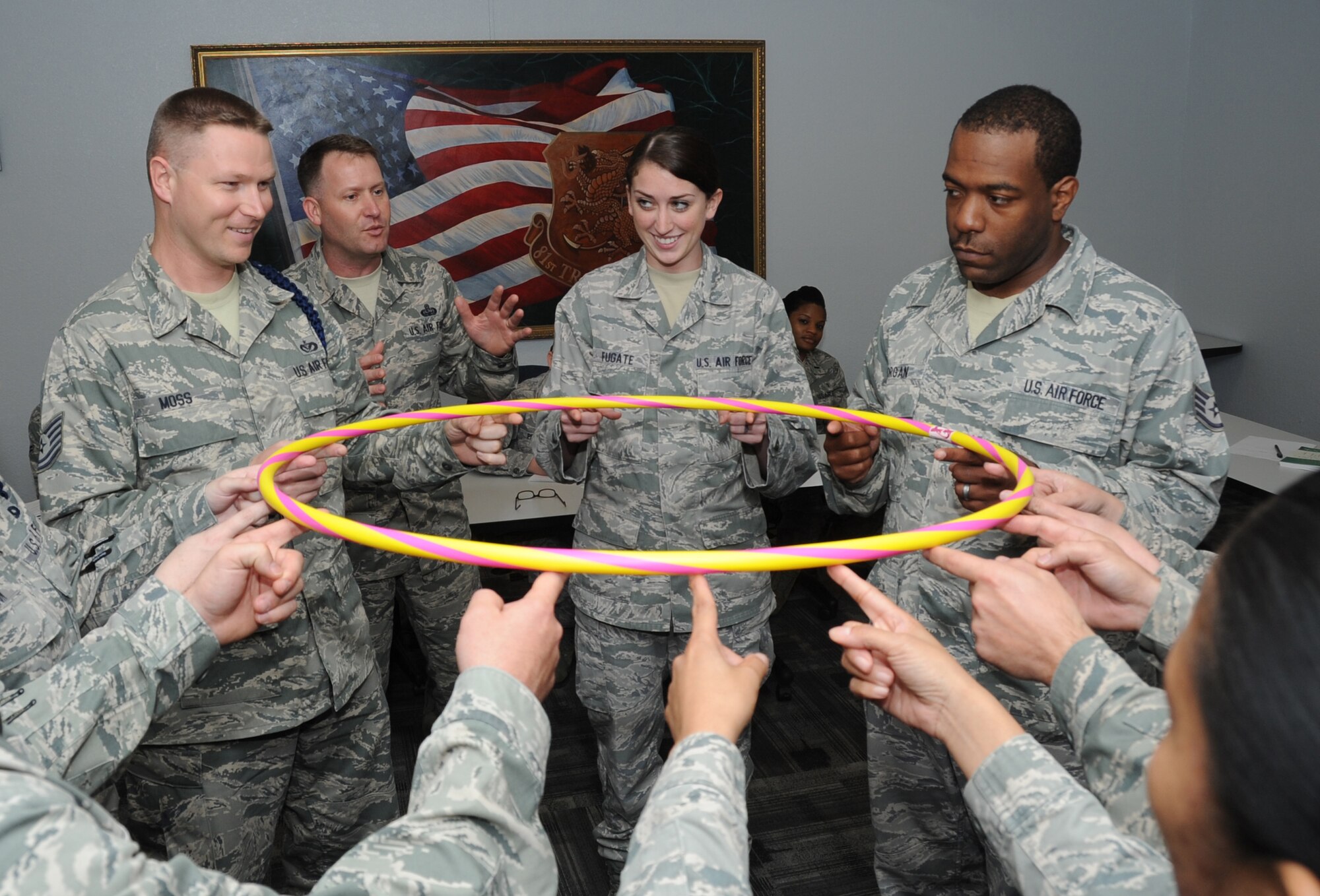 Tech. Sgt. Jedadiah Moss, 338th Training Squadron; Senior Master Sgt. Steven Mullens, 81st Force Support Squadron career assistance advisor; Senior Airman Taylor Fugate, 81st Medical Support Squadron; Staff Sgt. David Morgan, 81st Logistics Readiness Squadron, participate in a team building exercise, led by Mullens during a John Maxwell Winning With People leadership seminar March 22, 2012, at Keesler Air Force Base, Miss.  (U.S. Air Force photo by Kemberly Groue)