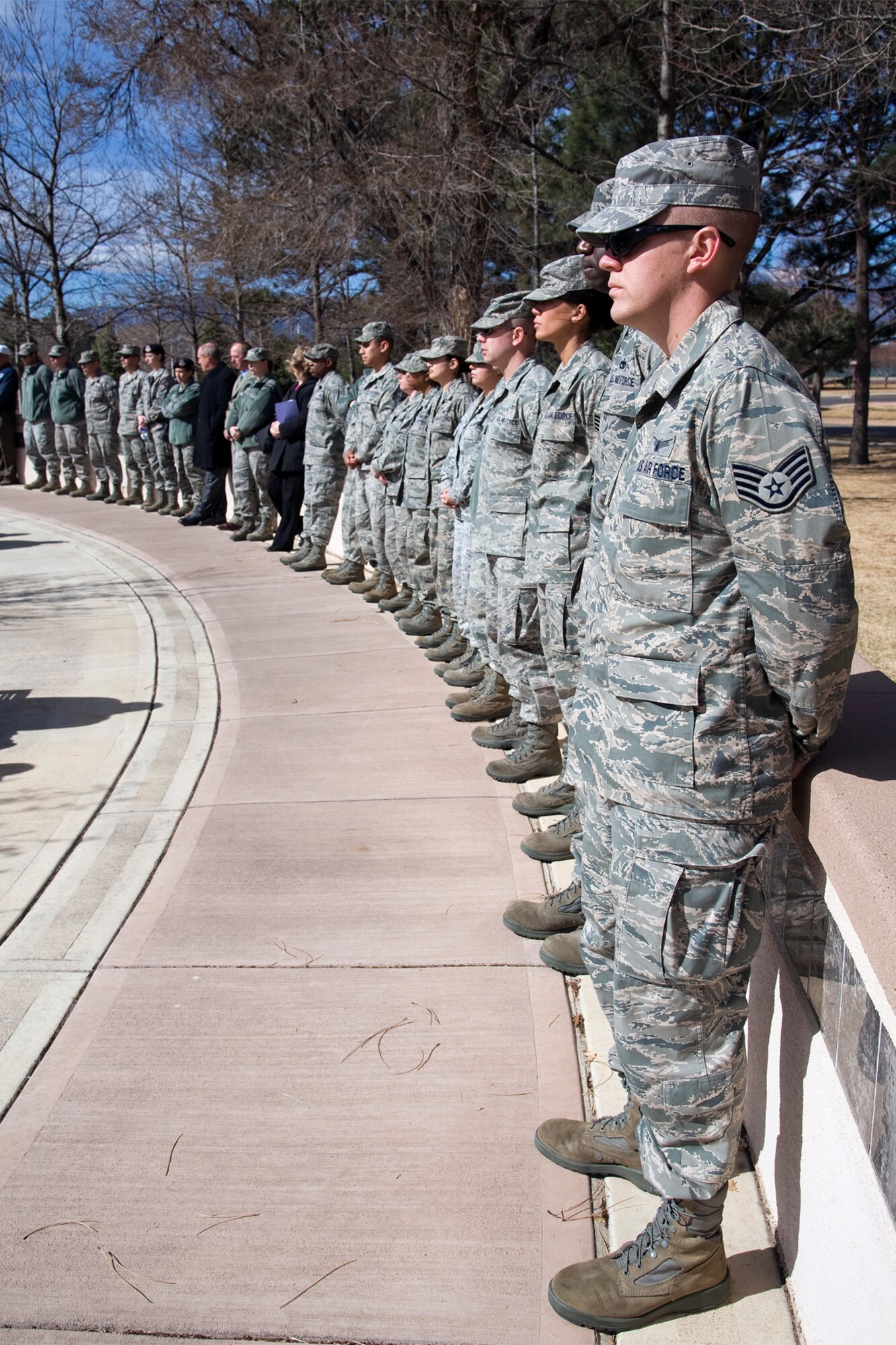 Scores of Airmen show their respect at the Peterson Medal of Honor memorial. Chief Master Sgt. Richard Etchberger, who was killed in the country of Laos during the Vietnam war, posthumously received the Medal of Honor in 2010, and his name was added to the Peterson memorial March 22. (U.S. Air Force photo/Craig Denton)