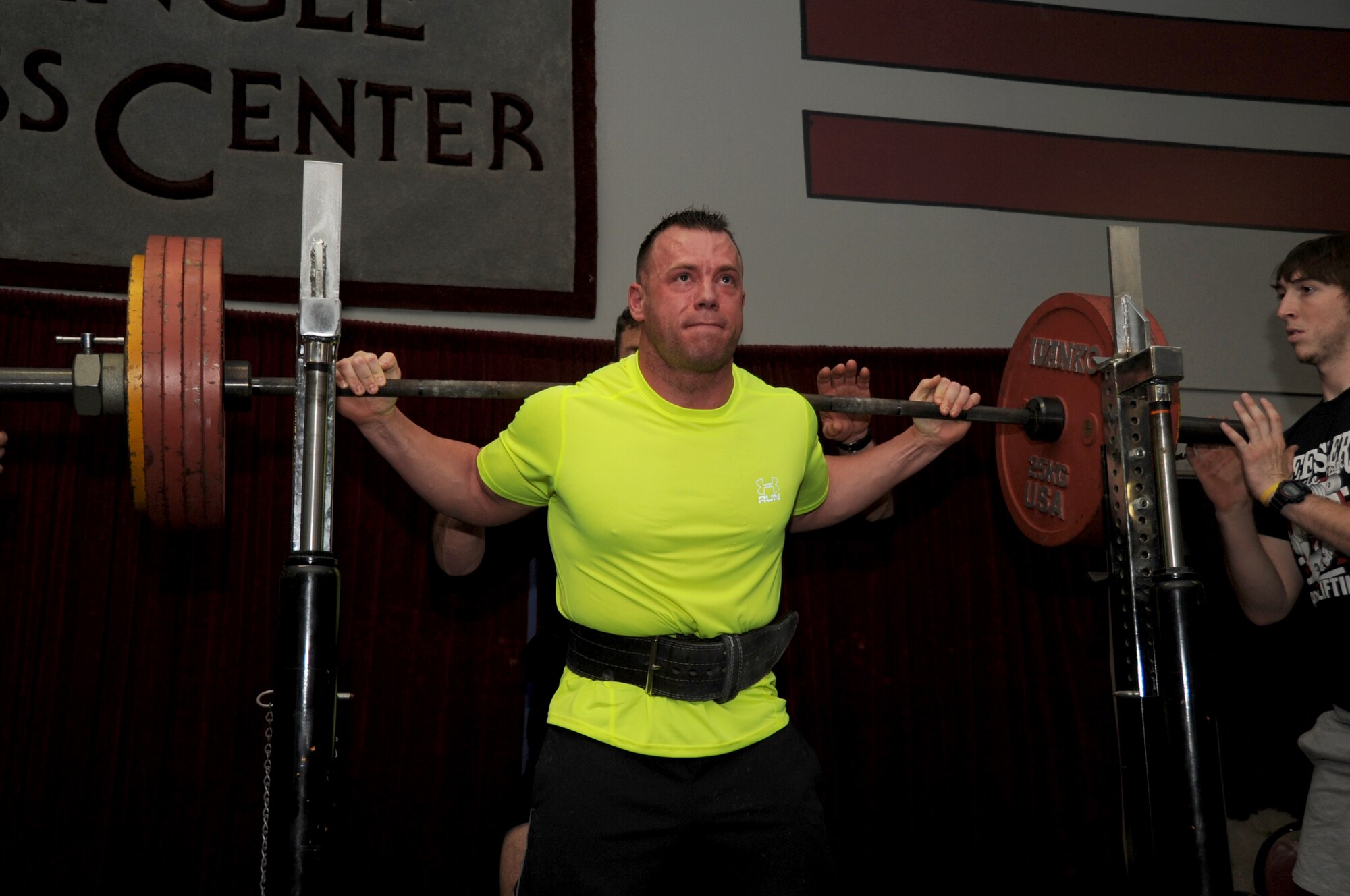 Staff Sgt. Austin Sutton, 81st Security Forces Squadron, squats 567.7 pounds to complete his third and final round of squats during the muscle mania competition March 24, 2012, at the Triangle Fitness Center, Keesler Air Force Base, Miss.  Sutton was the overall first place winner in the open raw division.  (U.S. Air Force photo by Kemberly Groue)