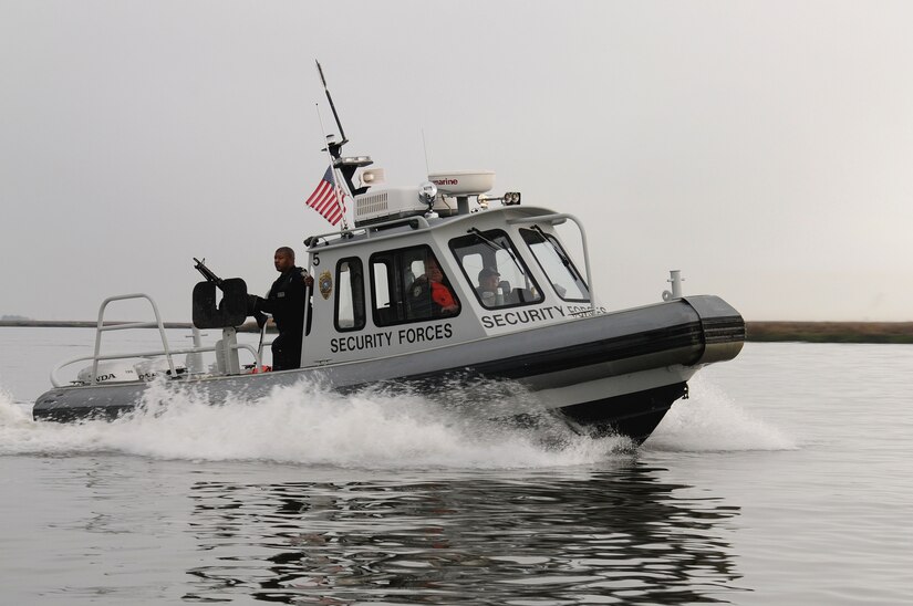 (Left to right) Patrolmen Dennis McKinney, William Stevens and George Cunningham, 628th Security Forces Squadron Harbor Patrol Unit, patrol the Cooper River Mar. 13. 628th SFS personnel are working to create new guidelines for the Harbor Patrol Unit at Joint Base Charleston that will satisfy both Air Force and navy requirements for waterfront security operations. McKinney, Stevens and Cunningham are 628th SFS HPU police officers. (U.S. Navy photo/Petty Officer 2nd Class Brannon Deugan)