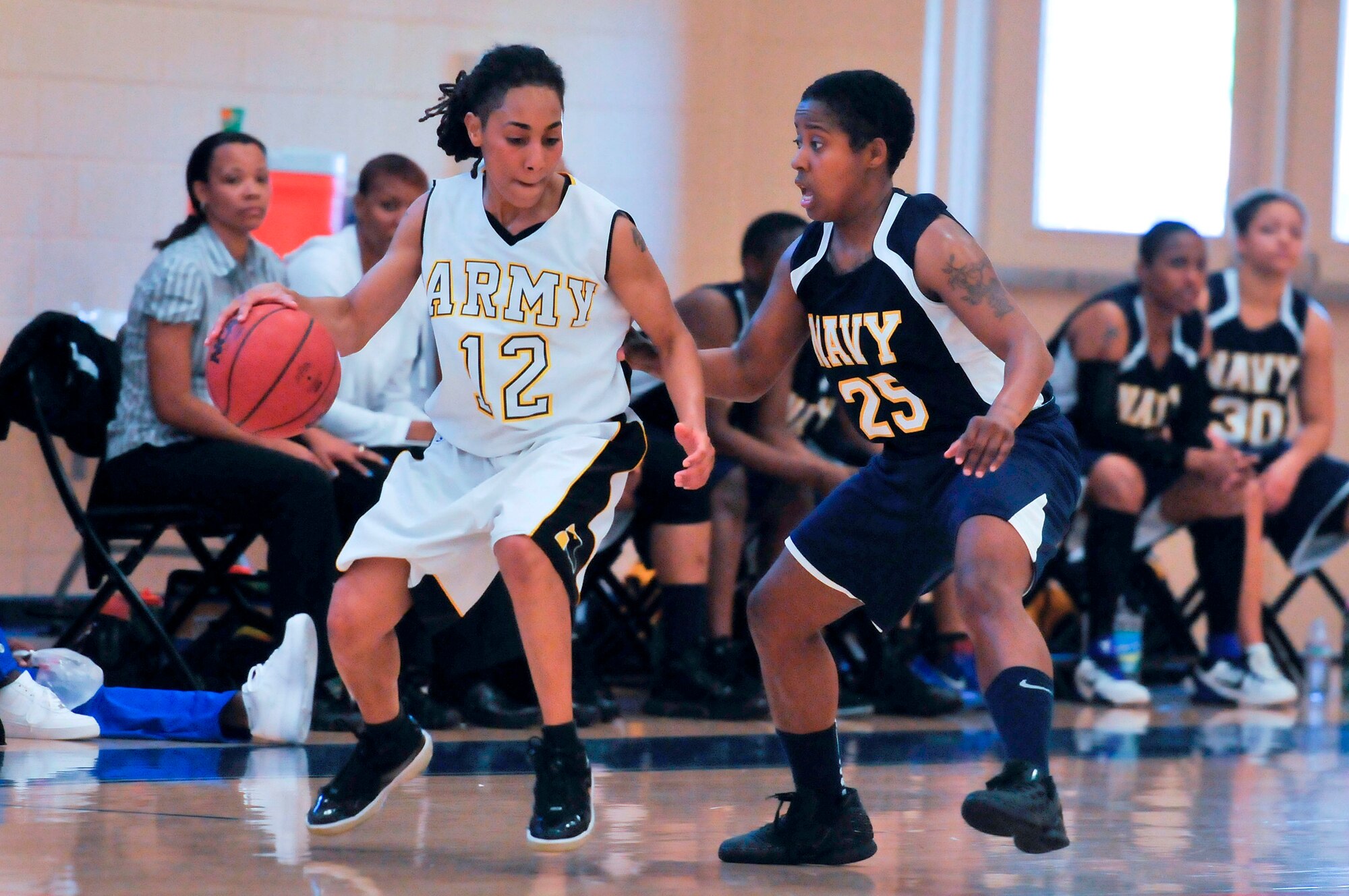 Specialist Ashley Bowman, Fort Meade, Md., dribbles the ball while Navy Airman Brittany White, VFA 195 Atsugi, Japan, guards her. During the second day of games of the Women’s Armed Forces Basketball Championship, the Navy and the Army faced-off. At half time the Navy still had a chance of coming back with a score of Army 42, Navy 35. But, the Army kept the lead with an ending score of Army – 82, Navy -63. (U.S Air Force photo by Chris Cokeing)