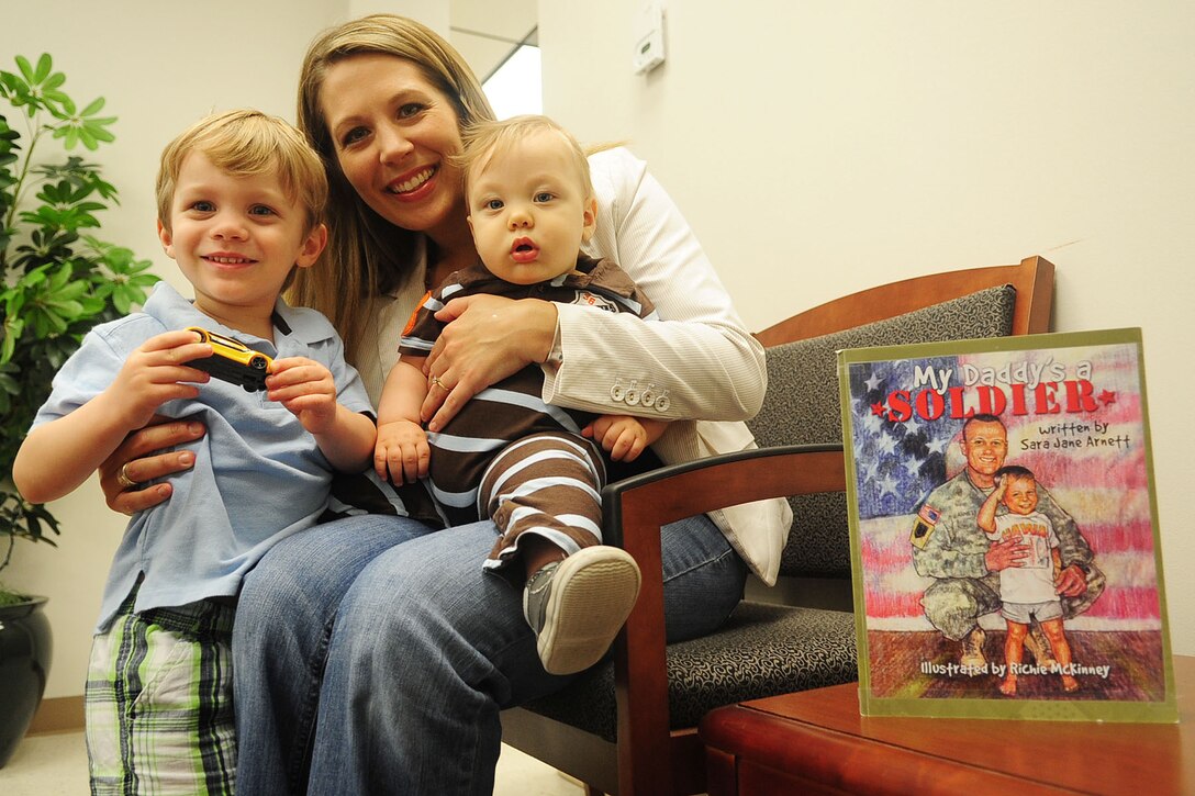To celebrate the Month of the Military Child, Sara Jane Arnett, wife of Capt. Samuel Arnett, Headquarters and Headquarters Company, Army Support Activity commander, wrote a book for her children, titled “My Daddy’s a Soldier.” The book was written as a resource to help other families with young children through the tough times of a deployment by sharing the experiences between father and son and how they get through it. (U.S. Air Force photo by Staff Sgt. Ashley Hawkins/Released)