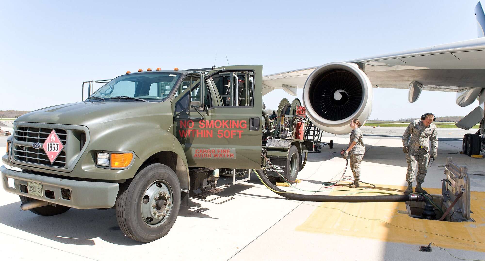 Airman 1st Class Katelyn Dittmer, left, and Airman 1st Class Jacob Heppler fuel distribution operators with the 436th Logistics Readiness Squadron, pump fuel into an aircraft March 23, 2012, on the Dover Air Force Base, Del., flight line. Fuel is pumped from pump houses on base through underground pipelines to the flight line. From there, fuel trucks pump the fuel from the pipeline into the aircraft. (U.S. Air Force photo by Roland Balik)