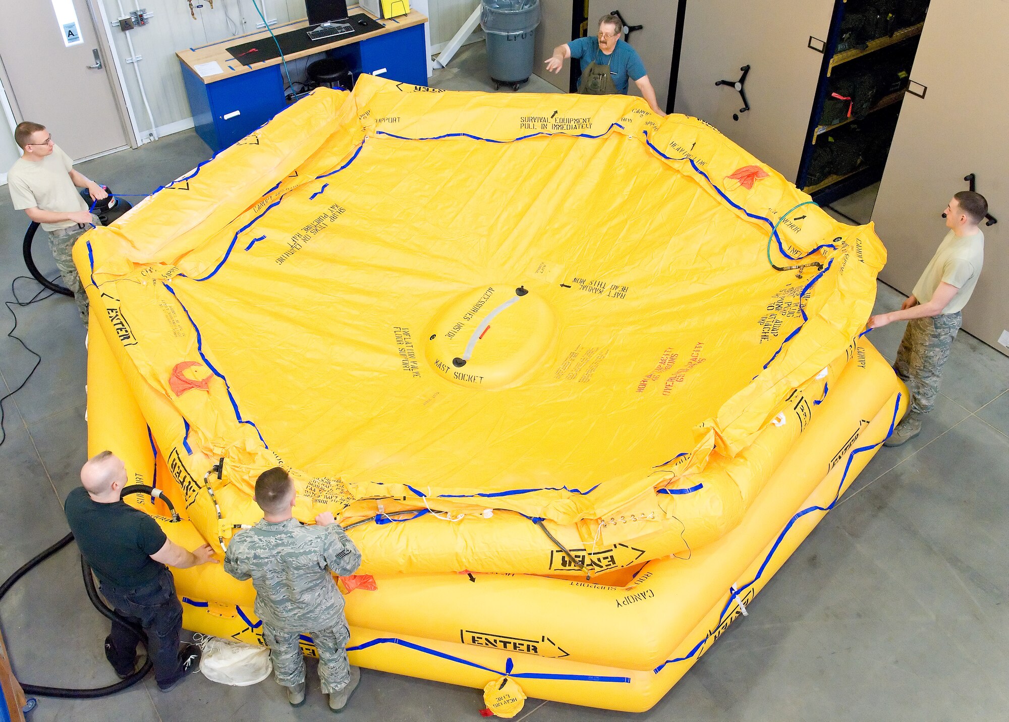Members of the 436th Operations Support Squadron Aircrew Flight Equipment section prepare three C-17 Globemaster III 46-man life rafts for leak checks March 19, 2012, at Dover Air Force Base, Del. The life rafts undergo inspection, to include pressure and leak checks, every three years. (U.S. Air Force photo by Roland Balik)