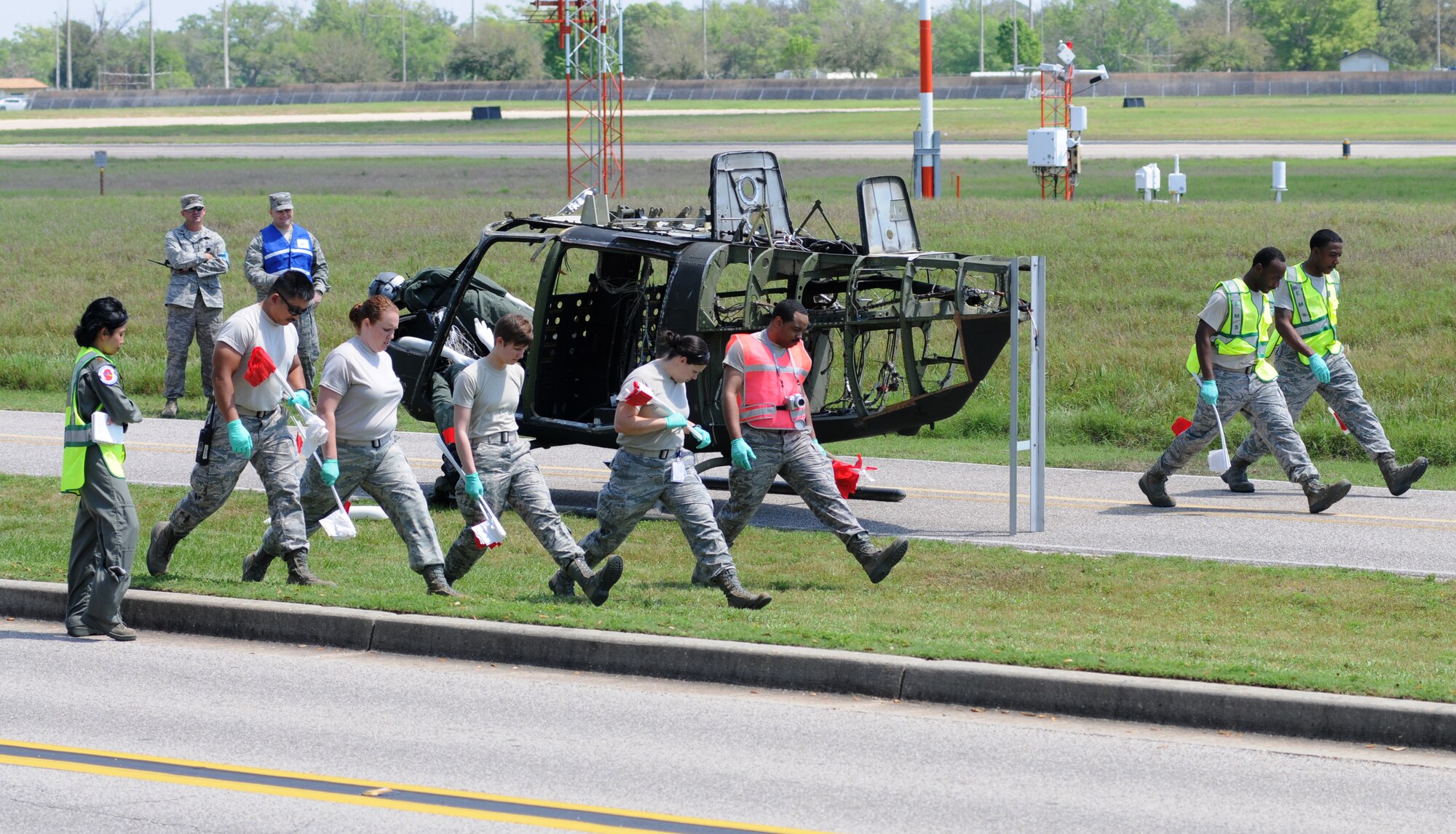 Members of the Keesler Medical Group conduct a search and recovery process during a major accident response exercise March 26, 2012, on I-81 across from the Marina at Keesler Air Force Base, Miss.  The exercise scenario included a Coast Guard MH-65C Dolphin helicopter crashing and causing a van to overturn resulting in four deaths and 13 injuries.  MAREs are conducted to test Keesler personnel’s response.  (U.S. Air Force photo by Kemberly Groue)