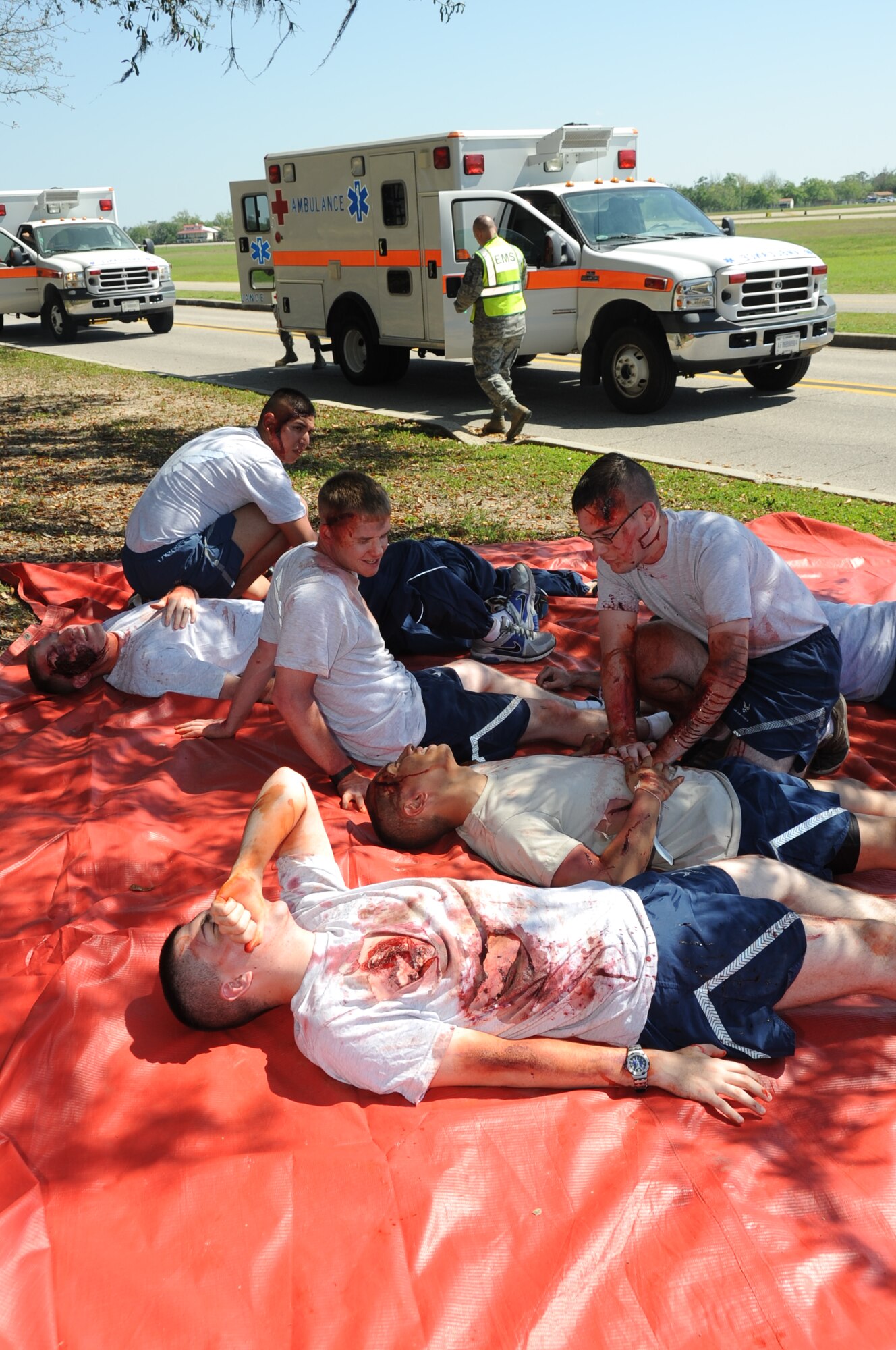 “Injured victims” wait for medical assistance in the triage area during a major accident response exercise March 26, 2012, on I-81 across from the Marina at Keesler Air Force Base, Miss. Prior to the exercise, those who volunteered to play the role of casualties were moulaged for a realistic effect. MAREs are conducted to test Keesler personnel’s response. MAREs are conducted to test Keesler personnel’s response.  (U.S. Air Force photo by Kemberly Groue)