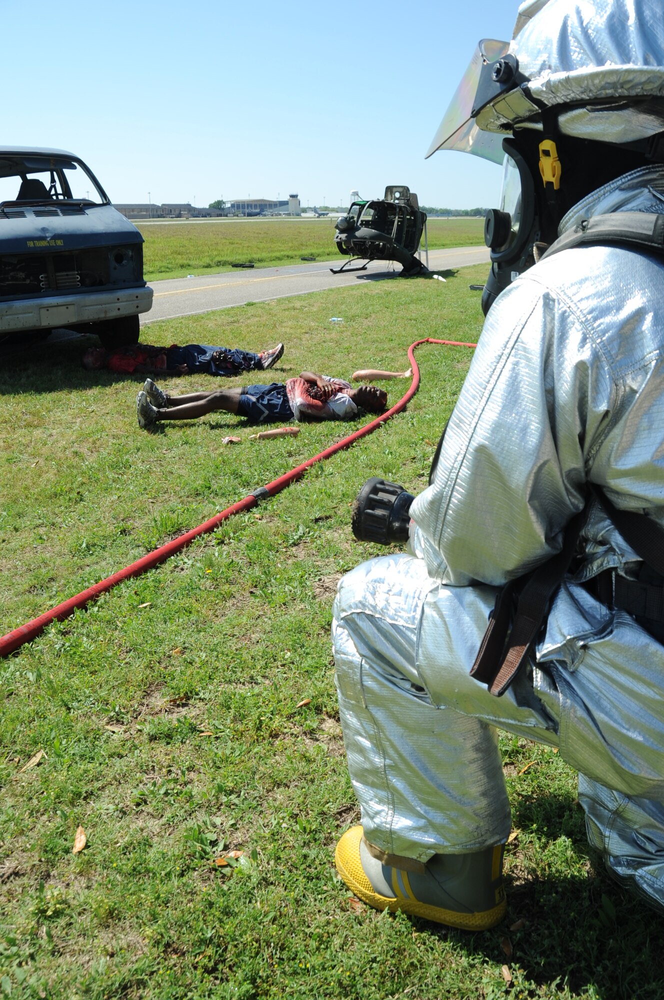 Keesler firefighters respond on scene during a major accident response exercise March 26, 2012, on I-81 across from the Marina at Keesler Air Force Base, Miss.  The exercise scenario included a Coast Guard MH-65C Dolphin helicopter crashing and causing a van to overturn resulting in four deaths and 13 injuries.  MAREs are conducted to test Keesler personnel’s response.  (U.S. Air Force photo by Kemberly Groue)
