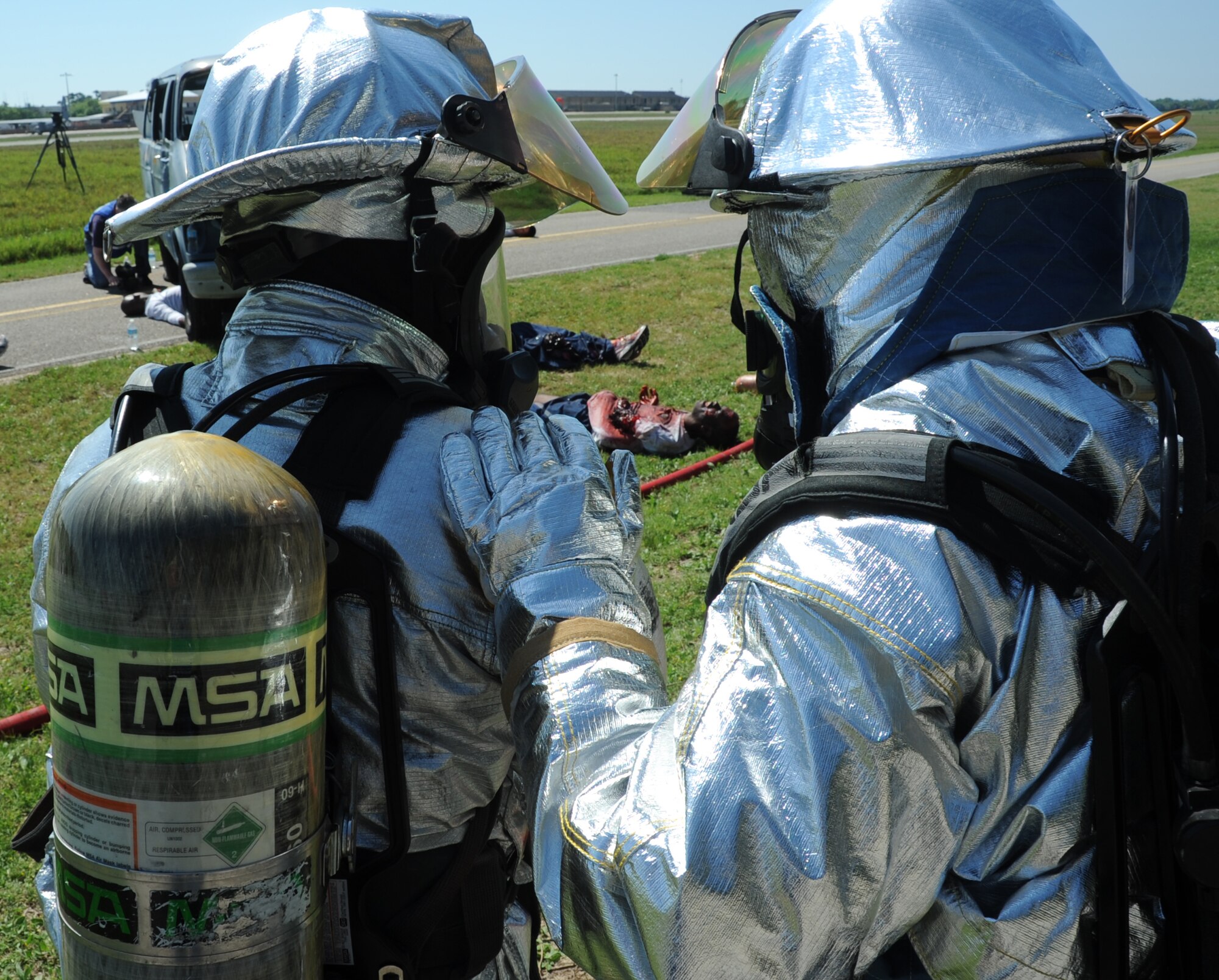 Keesler firefighters respond on scene during a major accident response exercise March 26, 2012, on I-81 across from the Marina at Keesler Air Force Base, Miss.  The exercise scenario included a Coast Guard MH-65C Dolphin helicopter crashing and causing a van to overturn resulting in four deaths and 13 injuries.  MAREs are conducted to test Keesler personnel’s response.  (U.S. Air Force photo by Kemberly Groue)