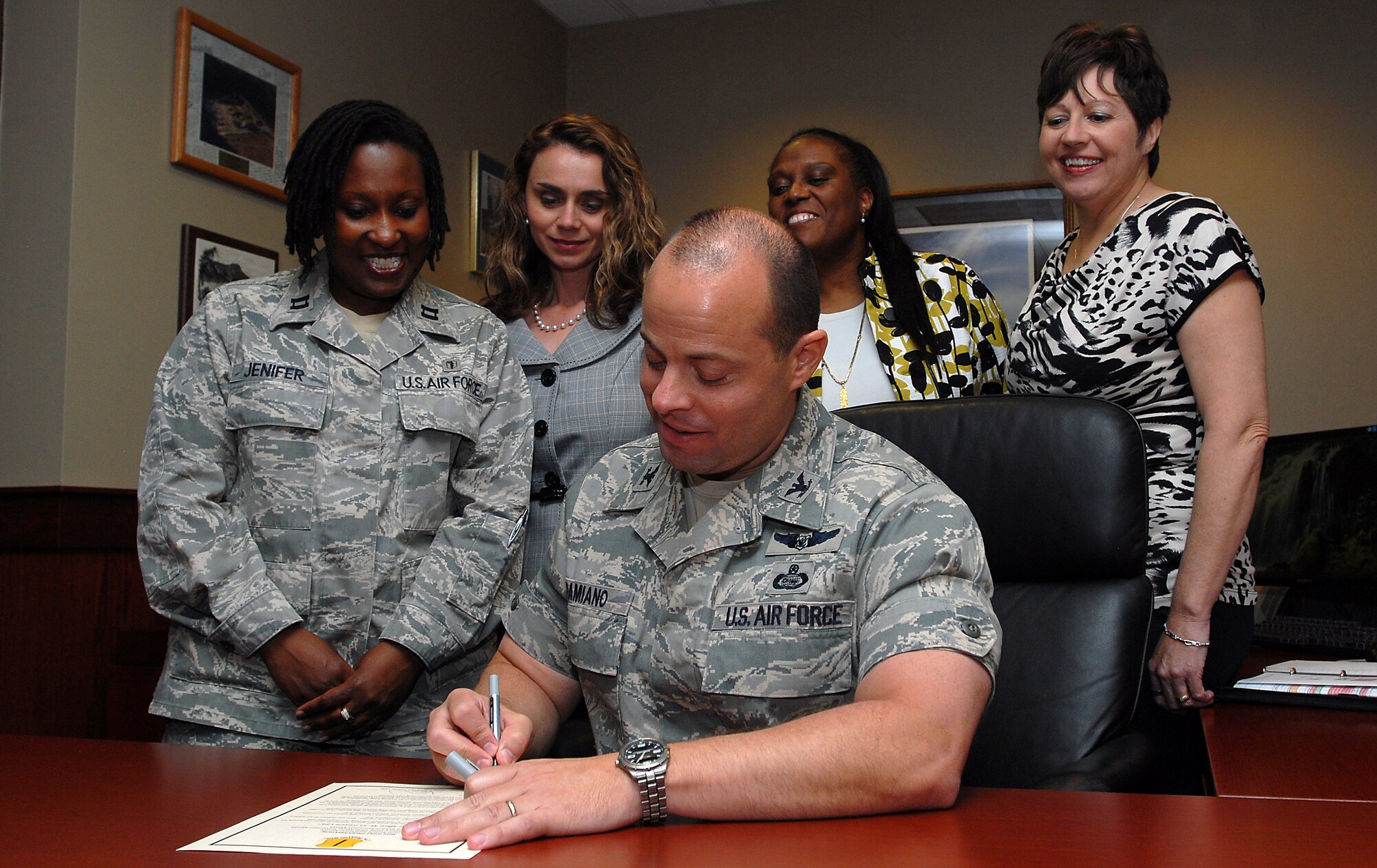 GOODFELLOW AIR FORCE BASE, Texas-- Col. Mark Damiano, 17th Training Wing Commander, signs the 2012 Joint Proclamation with members of Sexual Assault Prevention Response Team, Airman & Family Readiness Center, and Family Advocacy March 21, here. The proclamation dedicates the month of April to be Sexual Assault Awareness Month, Month of the Military Child, Child Abuse Prevention Month, and Alcohol Awareness Month. (U.S. Air Force photo/ Airman 1st Class Michael Smith)