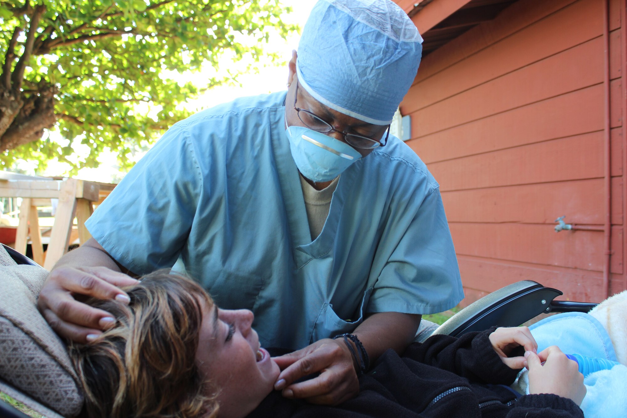 Maj. Tiffiney T. Harper, 192nd Medical Group chief of dental services, provides dental care for a young patient March 7 during Tropic Care in Hawaii. More than 40 members of the Virginia Air National Guard's 192nd MDG deployed to Kaua'i, Hawaii, from Feb. 27 to March 9 to participate in the first Tropic Care Innovative Readiness Training operation. (Courtesy photo)