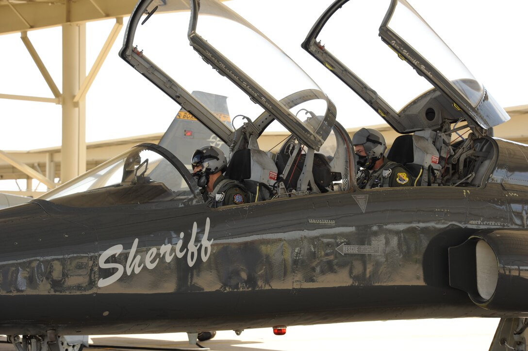 Brig. Gen. Darryl Burke, 82nd Training Wing commander, sits in the back seat of a T-38 in the ENJPPT aircraft parking area with Maj. Brian Collins of the 80th Operational Support Squadron during pre-flight operations before his "fini-flight" on Mar. 26, 2012 at Sheppard Air Force Base, Texas.  Fini-flights are a long-standing military aviator tradition honoring a pilot or commander on their departure from an assignment. (U.S. Air Force photo/Danny Webb)
