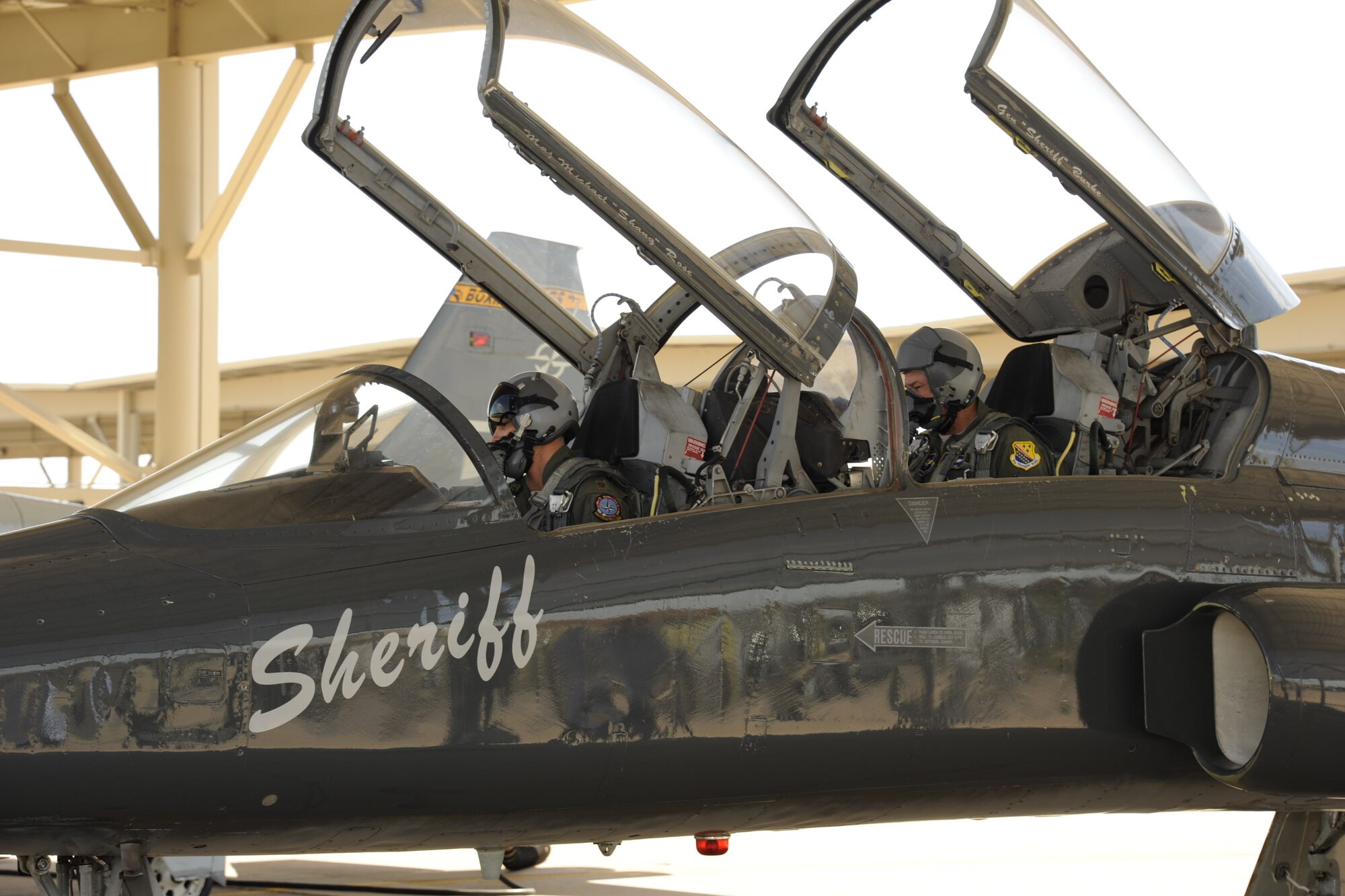 Brig. Gen. Darryl Burke, 82nd Training Wing commander, sits in the back seat of a T-38 in the ENJPPT aircraft parking area with Maj. Brian Collins of the 80th Operational Support Squadron during pre-flight operations before his "fini-flight" on Mar. 26, 2012 at Sheppard Air Force Base, Texas.  Fini-flights are a long-standing military aviator tradition honoring a pilot or commander on their departure from an assignment. (U.S. Air Force photo/Danny Webb)