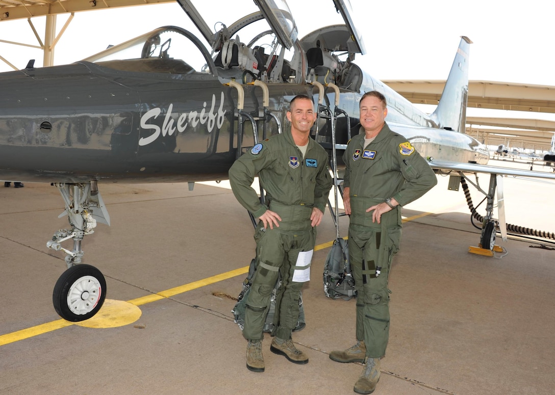 Brig. Gen. Darryl Burke, 82nd Training Wing commander, stands in front of a T-38 in the ENJPPT aircraft parking area with Maj. Brian Collins of the 80th Operational Support Squadron before his "fini-flight" on Mar. 26, 2012.  Fini-flights are a long-standing military aviator tradition honoring a pilot or commander on their departure from an assignment. (U.S, Air Force photo/Danny Webb)
