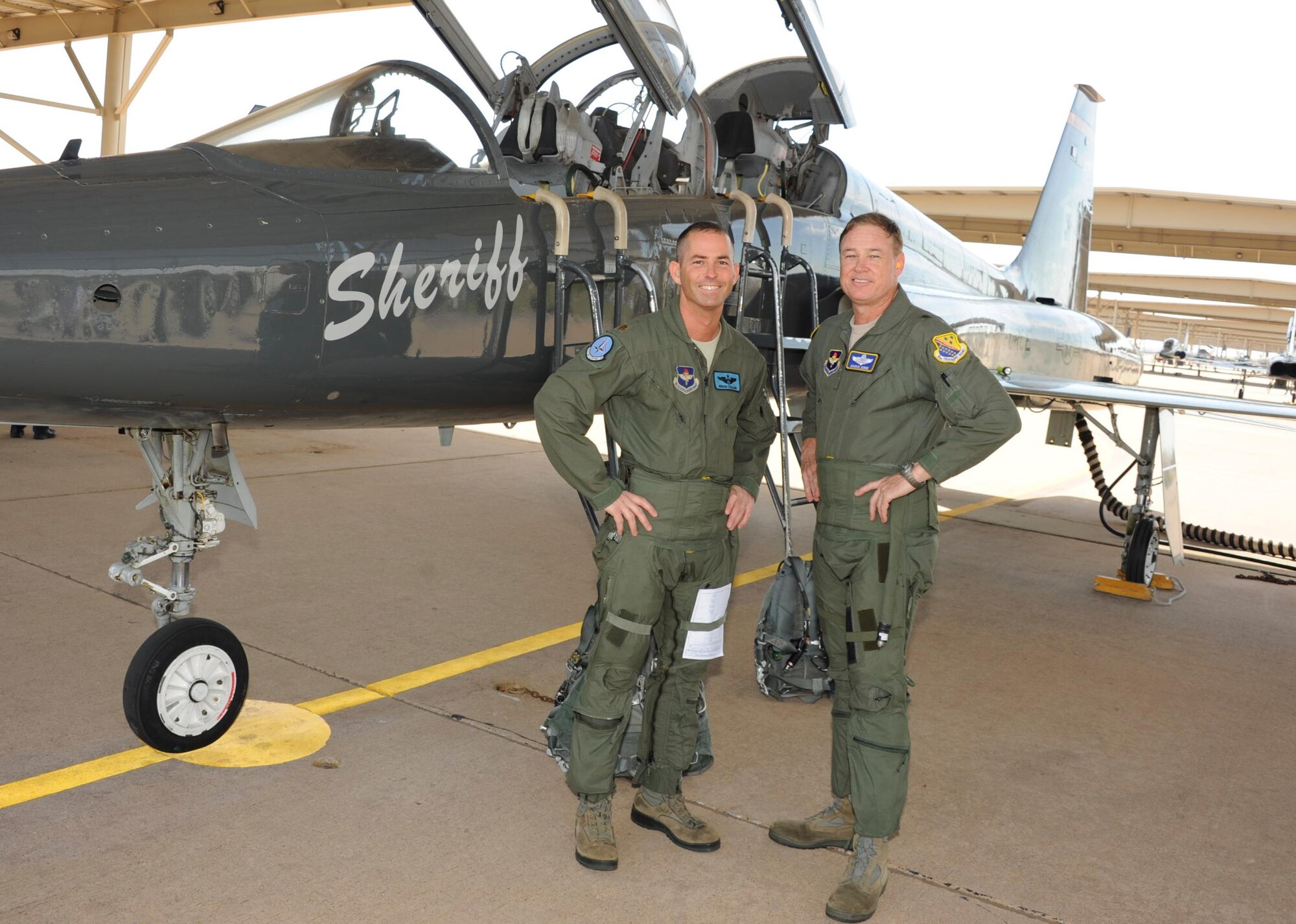 Brig. Gen. Darryl Burke, 82nd Training Wing commander, stands in front of a T-38 in the ENJPPT aircraft parking area with Maj. Brian Collins of the 80th Operational Support Squadron before his "fini-flight" on Mar. 26, 2012.  Fini-flights are a long-standing military aviator tradition honoring a pilot or commander on their departure from an assignment. (U.S, Air Force photo/Danny Webb)
