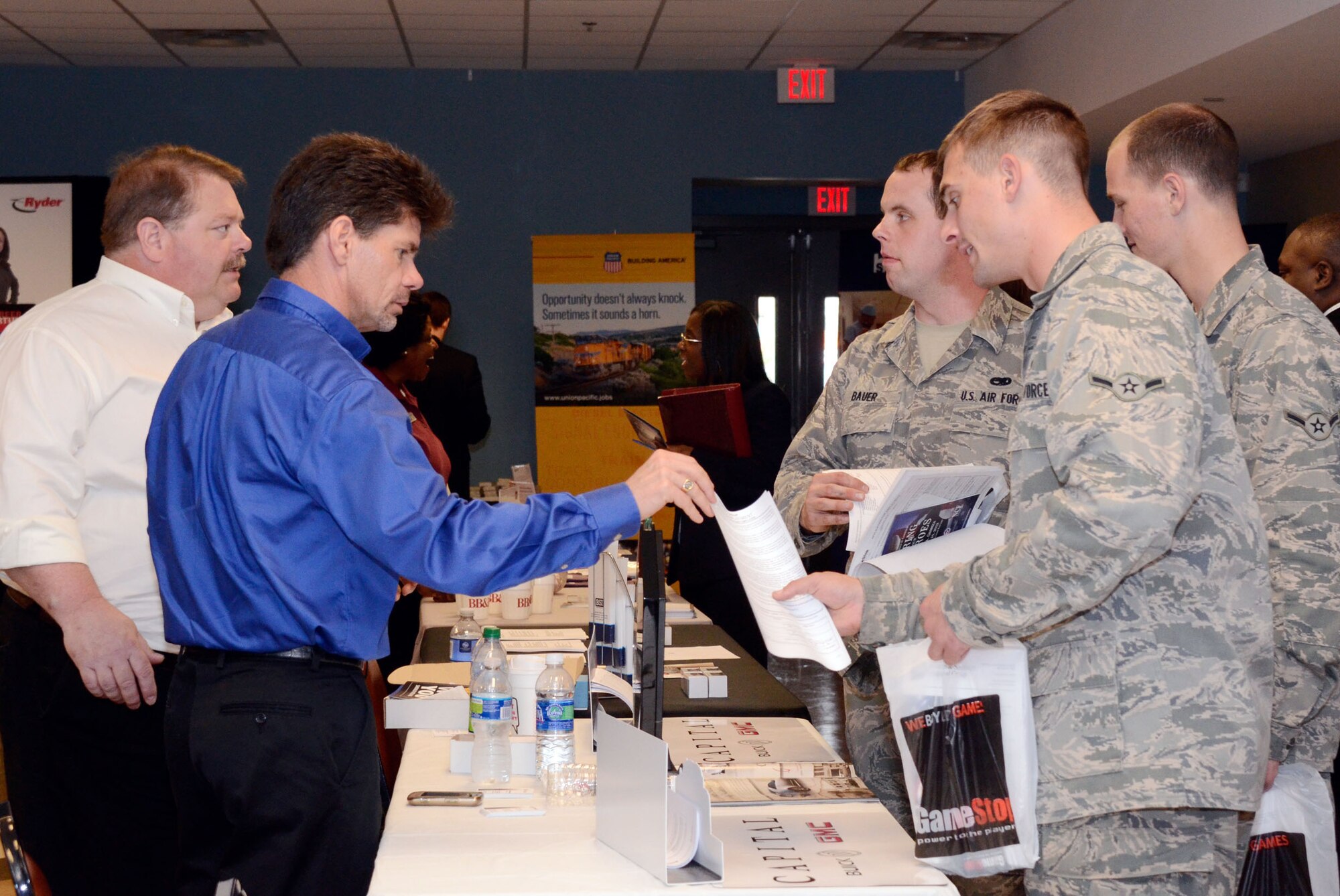 Representatives Tony Dutton and Ross Long from Capital Buick GMC, visit with 3 Airmen from the 94th Maintenance Squadron, Dobbins Air Reserve Base, Ga. Companies offered up employment opportunities to veterans during a "Hiring Our Heroes" hiring fair held at the American Legion Post #160, Smyrna, Ga., March 16. (U.S. Air Force photo/Don Peek)