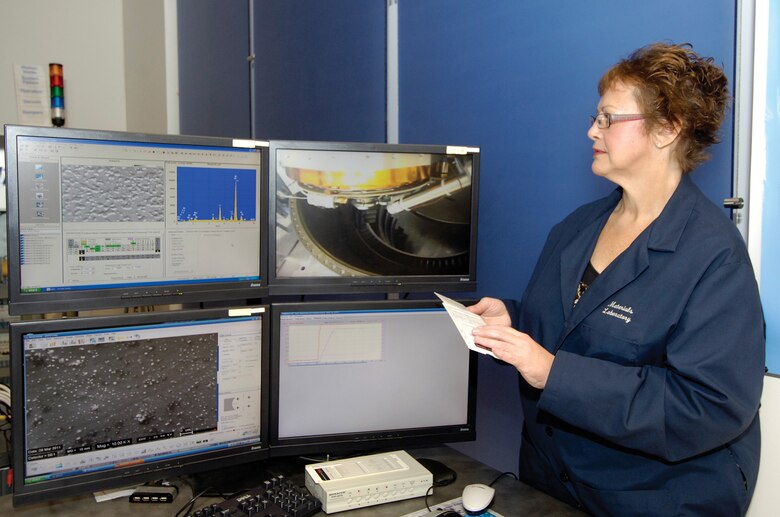 Judith Freer, 76th Maintenance Support Squadron senior materials engineering technician, reviews data fed from the nearby MIRA X scanning electron microscope. The 125 cubic-foot chamber makes it the largest SEM in the world and allows parts to be scanned whole instead of cutting them up, saving thousands of dollars when a new part is found to be service-able and can meet Tinker’s strict requirements. This non-destructive approach saves money on parts and helped pay for the $2.2 million microscope within three years.(Air Force photo by Margo Wright)