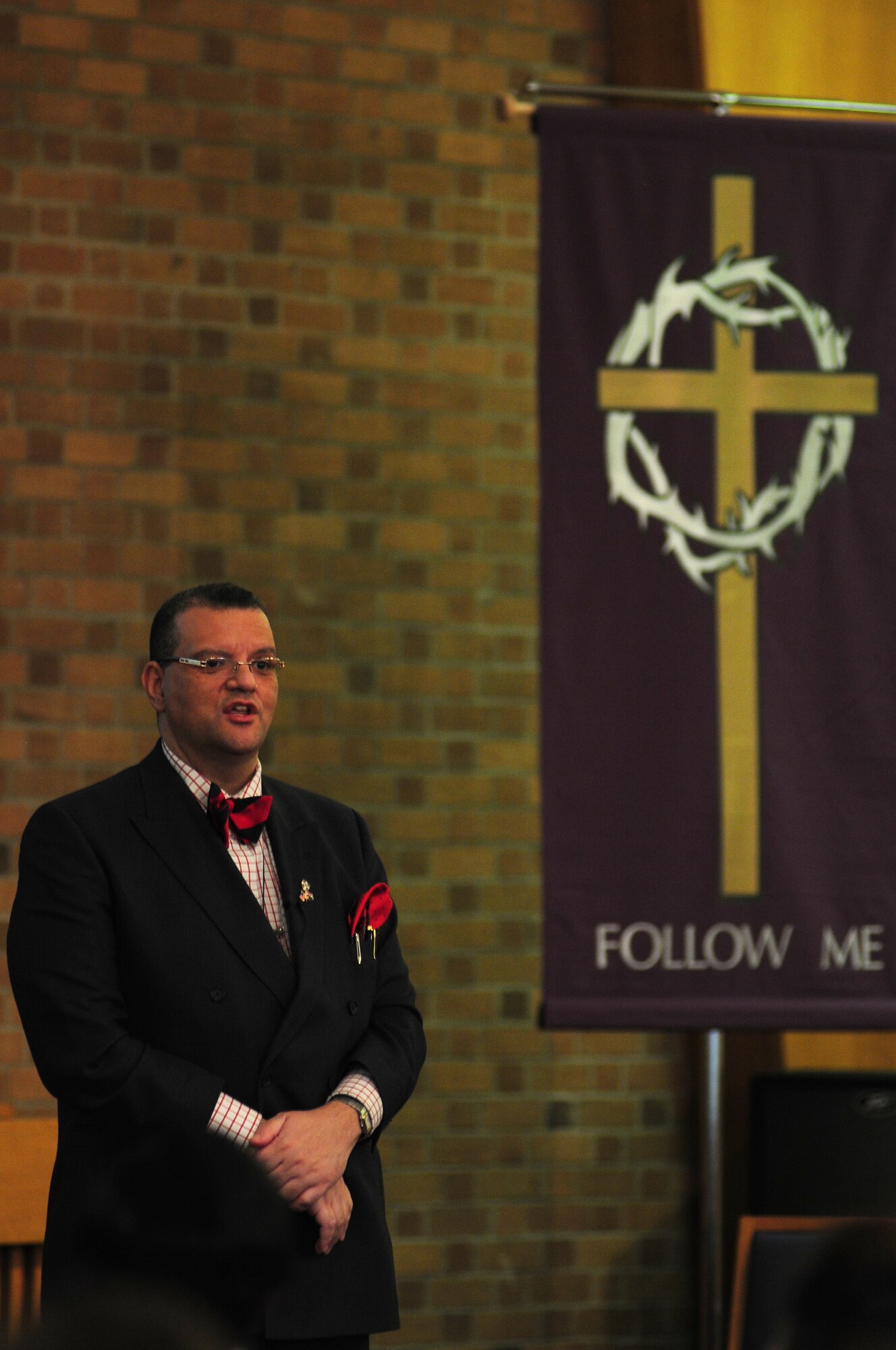 ROYAL AIR FORCE LAKENHEATH, England – The Rev. Canon Andrew White, St. George’s Church vicar, speaks to military members and their families March 24, 2012. St. George’s Church is the largest remaining Anglican church in Iraq, ministering to more than 550 local Iraqi Christian families, which has led to White being known as the “Vicar of Baghdad.” Additionally the St. George’s Clinic, located in the church compound, provides free medical and dental care to approximately 2,000 Iraqi patients every month. (U.S. Air Force photo by Airman 1st Class Cory D. Payne)