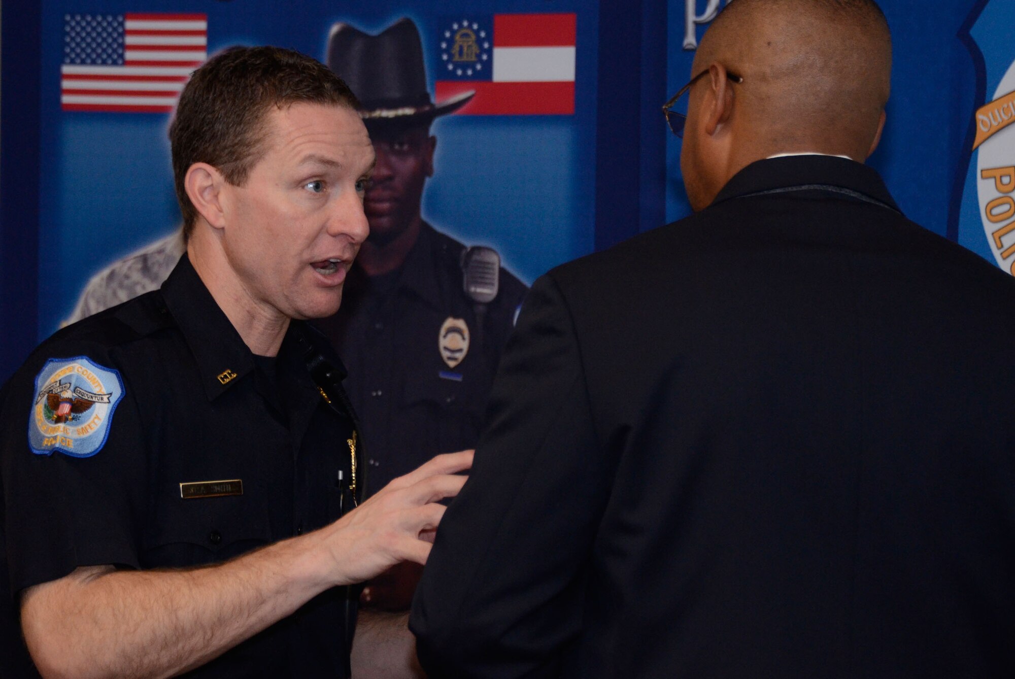 Detective C. A. Smith, Recruiting and Background investigator with the Cobb County Department of Public Safety, Marietta, Ga. outlines details of becoming a member of the force to an interested veteran during a "Hiring Our Heroes" hiring fair held at the American Legion Post #160, Smyrna, Ga., March 16. (U.S. Air Force photo/Don Peek)