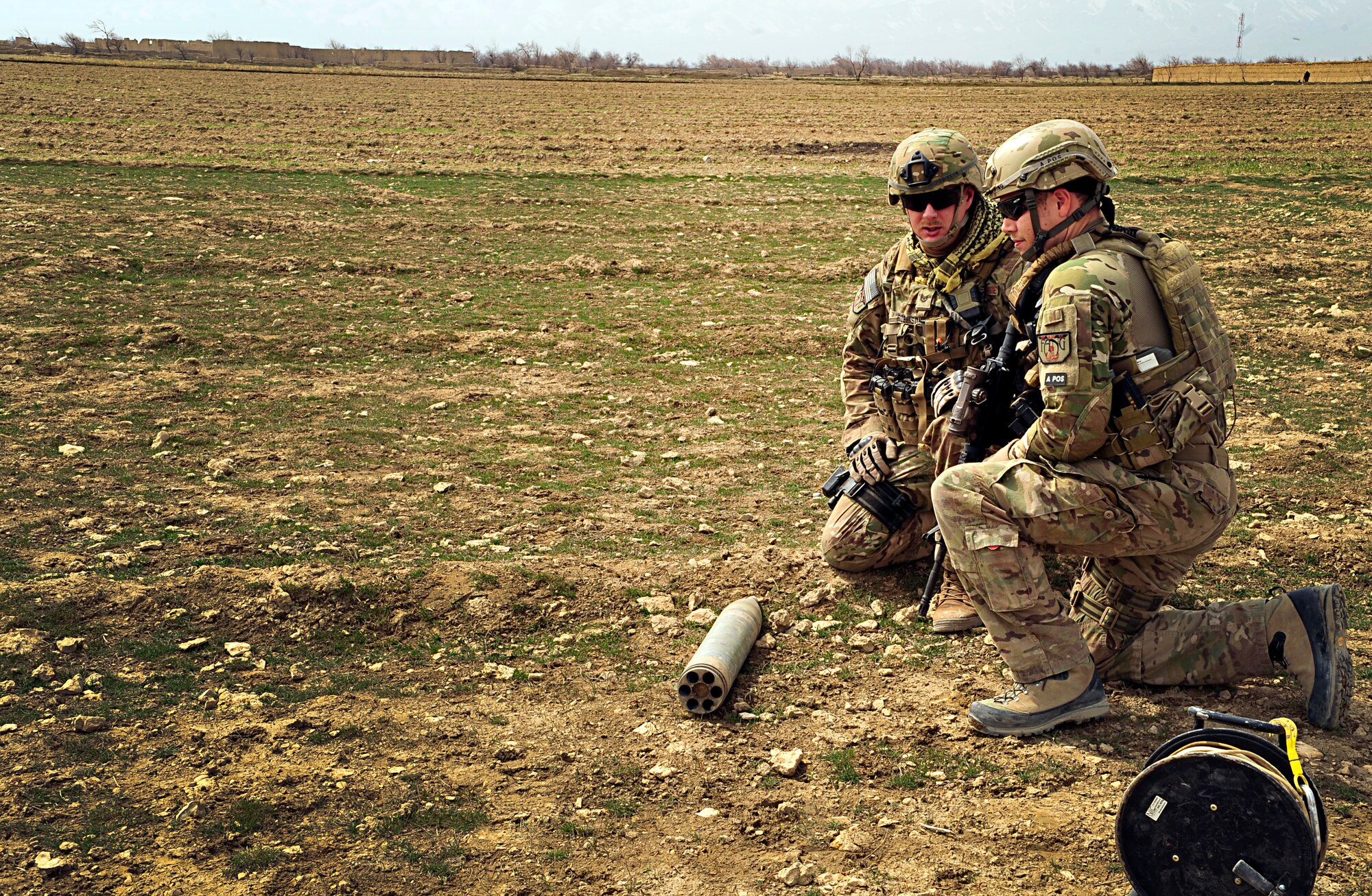 Tech. Sgt. Daniel K. Robinson and Staff Sgt. David Fleming, Explosive Ordnance Disposal technicians with the 966th Air Expeditionary Squadron and Combined Joint Task Force Paladin, kneel next to an unexploded ordnance that was reported found off base at Bagram Airfield, Afghanistan, March 19, 2012. The EOD flight with the 966th AES is tasked to mitigate, render safe, or destroy any conventional or unconventional explosive threat as well as chemical, nuclear or biological hazards inside and outside the wire. Their operations can be performed 24-hours a day, seven days a week. Some of their responsibilities as EOD technicians include mitigating improvised explosive devices, post blast analysis and route clearing packages. (U.S. Air Force photo/Staff Sgt. Sara Csurilla)