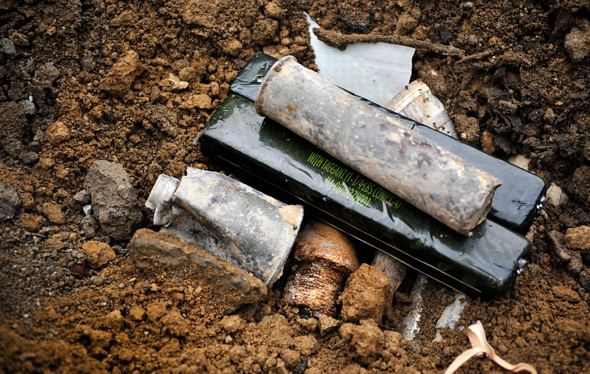 A stick of C-4 is mixed with unexploded ordnances before Airmen with the 966th Air Expeditionary Squadron Explosive Ordnance Disposal team perform a controlled detonation at Bagram Airfield, Afghanistan, March 16, 2012. The EOD flight with the 966th AES is tasked to mitigate, render safe, or destroy any conventional or unconventional explosive threat as well as chemical, nuclear or biological hazards inside and outside the wire. Their operations can be performed 24-hours a day, seven days a week. Some of their responsibilities as EOD technicians include mitigating improvised explosive devices, post blast analysis and route clearing packages. (U.S. Air Force photo/Staff Sgt. Sara Csurilla)