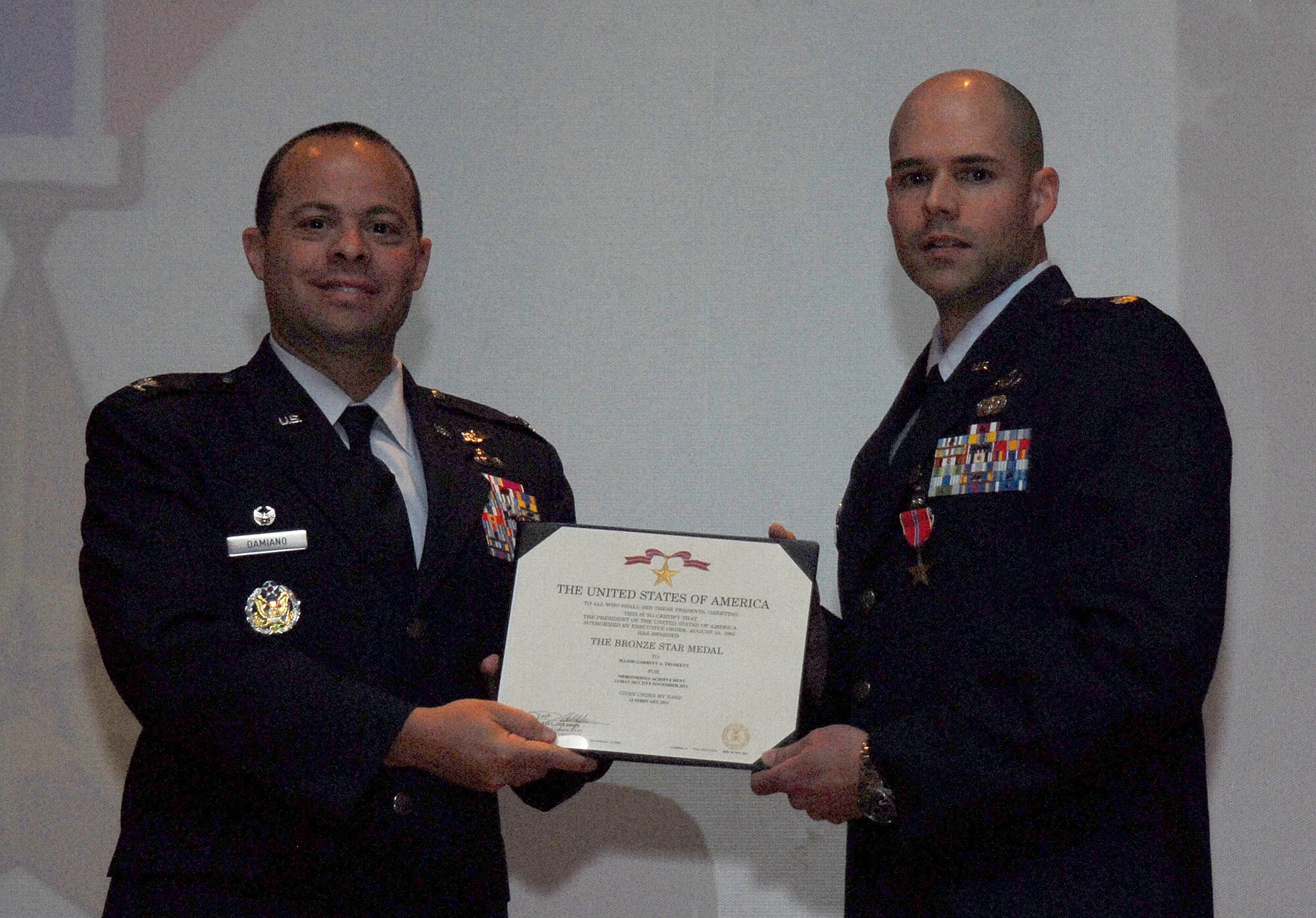 GOODFELLOW AIR FORCE BASE, Texas -- Col. Mark Damiano, 17th Training Wing Commander, presents Maj. Garrett Truskett, 17th Contracting Squadron Commander, with a Bronze Star March 23. Maj. Truskett received this Bronze Star for his meritorious achievements as Chief of Shank Regional Contracting Center, while deployed in Afghanistan. (U.S. Air Force photo/ Airman 1st Class Michael Smith)