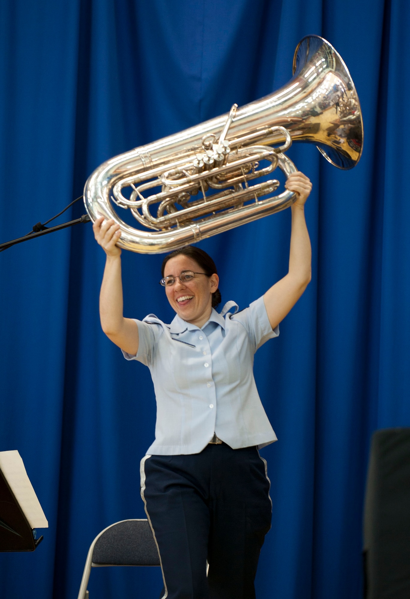 Staff Sgt. Meredith Healy, tuba player for U.S. Air Forces in Europe Band "Wings of Dixie," shows off a tuba after a solo March 22, 2012, at Incirlik Air Base, Turkey. Wings of Dixie performed several times for the school as part of the Music in Our Schools program and put on a show for members of Team Incirlik in the Club Complex ballroom March 23. (U.S. Air Force photo by Senior Airman Clayton Lenhardt/Released)