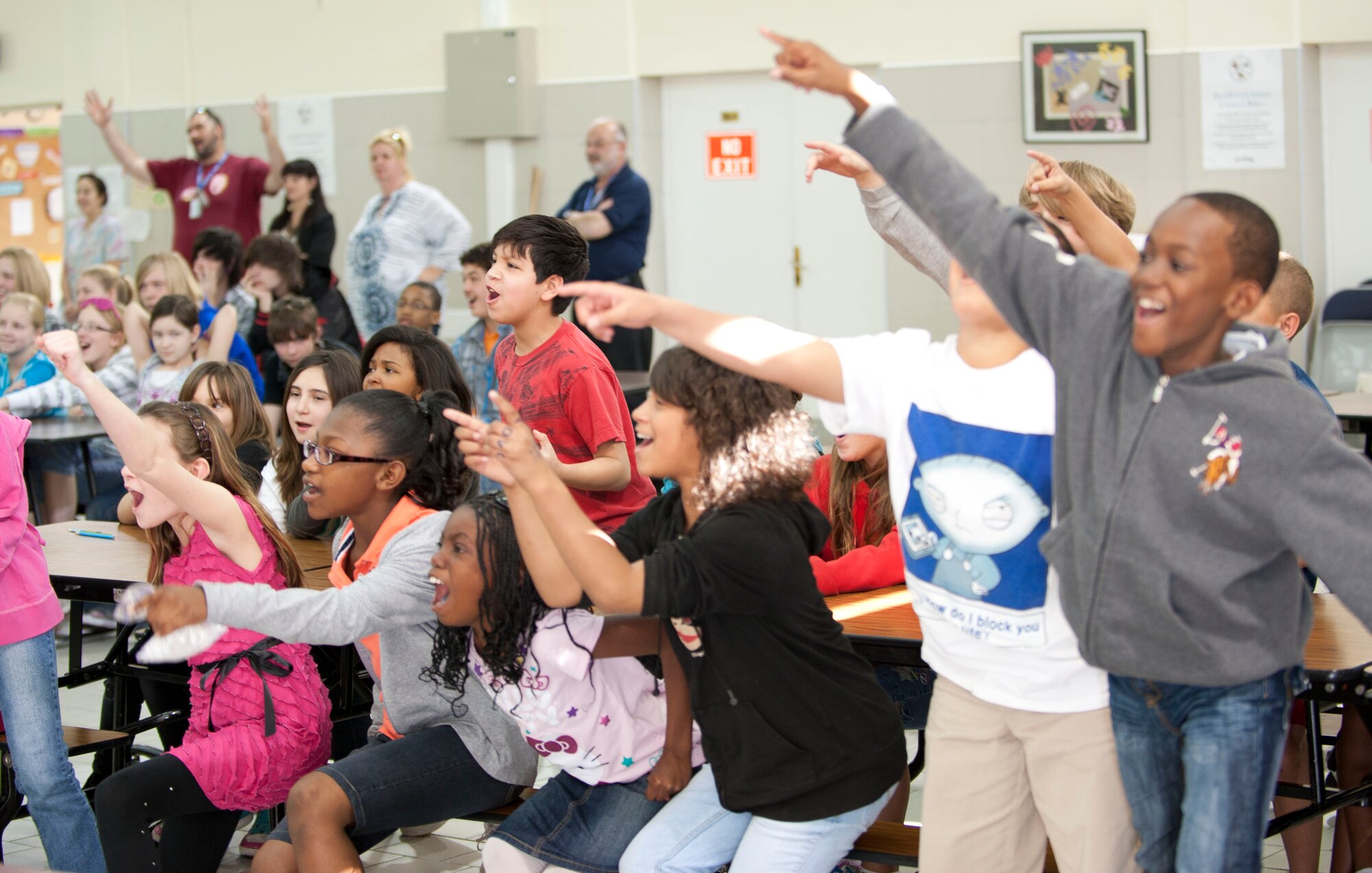 Children cheer during a U.S. Air Forces in Europe Band "Wings of Dixie" performance in the Incirlik Unit School multipurpose room March 22, 2012, at Incirlik Air Base, Turkey. Wings of Dixie performed several times for the school as part of the Music in Our Schools program and put on a show for members of Team Incirlik in the Club Complex ballroom March 23. (U.S. Air Force photo by Senior Airman Clayton Lenhardt/Released)