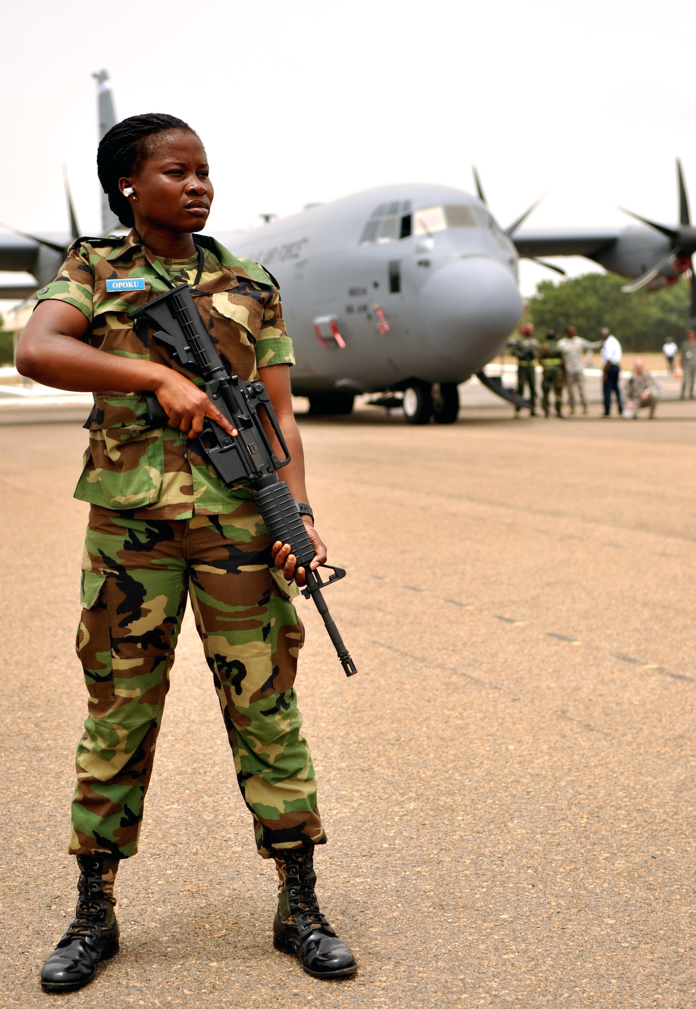 ACCRA, Ghana --  Ghanaian air force Lance Cpl. Lydia Opoku, GAF general duties, guards a U.S. Air Force C-130J Hercules on the airfield here during African Partnership Flight 12-2’s capstone event March 21. U.S. Air Forces Africa APF 12-2 is a military-to-military partnership building exercise event providing all air forces involved the opportunity to exchange techniques and learn from one another. Opoku was the only female in security forces in the partnership exercise. (U.S. Air Force photo by Senior Airman Natasha Stannard/Released)