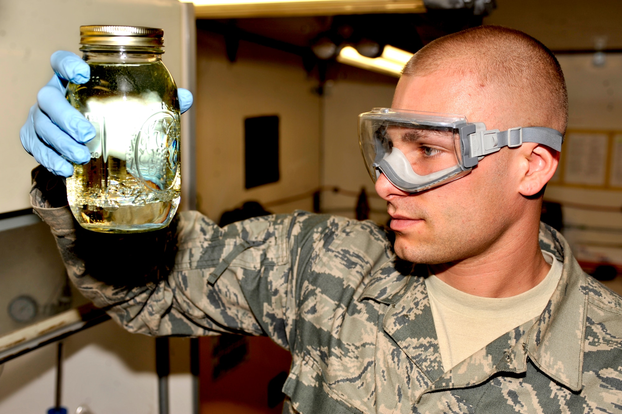 BAGRAM AIRFIELD, Afghanistan—Staff Sgt. Joshua Chapin examines a jar of jet fuel at Bagram Airfield, Afghanistan, March 27, 2012. Chapin is a fuels laboratory supervisor with the 455th Expeditionary Logistics Readiness Squadron and is deployed from Davis-Monthan Air Force Base, Ariz. (U.S. Air Force photo/Airman 1st Class Ericka Engblom)