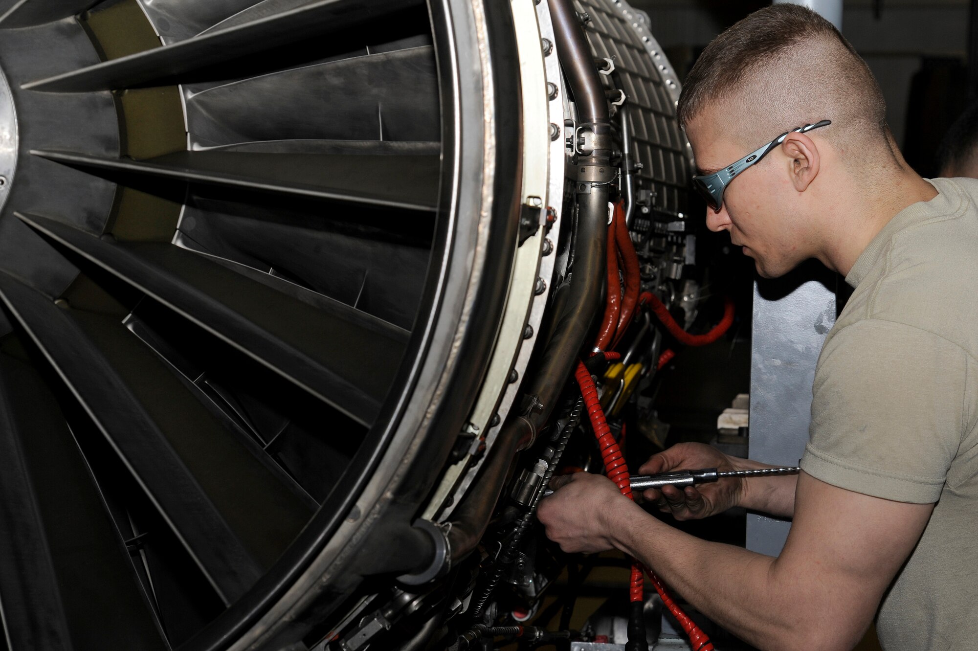 U.S. Air Force Senior Airman Stephen Spencer, 35th Maintenance Squadron aerospace propulsion journeyman, breaks down an F-16 Fighting Falcon F110-100 model engine at Misawa Air Base, Japan, March 27, 2012. Both Osan and Kunsan uses the 100 model engine while Misawa uses the 129 model engine.  (U.S. Air Force photo by Tech. Sgt. Marie Brown/Released)
