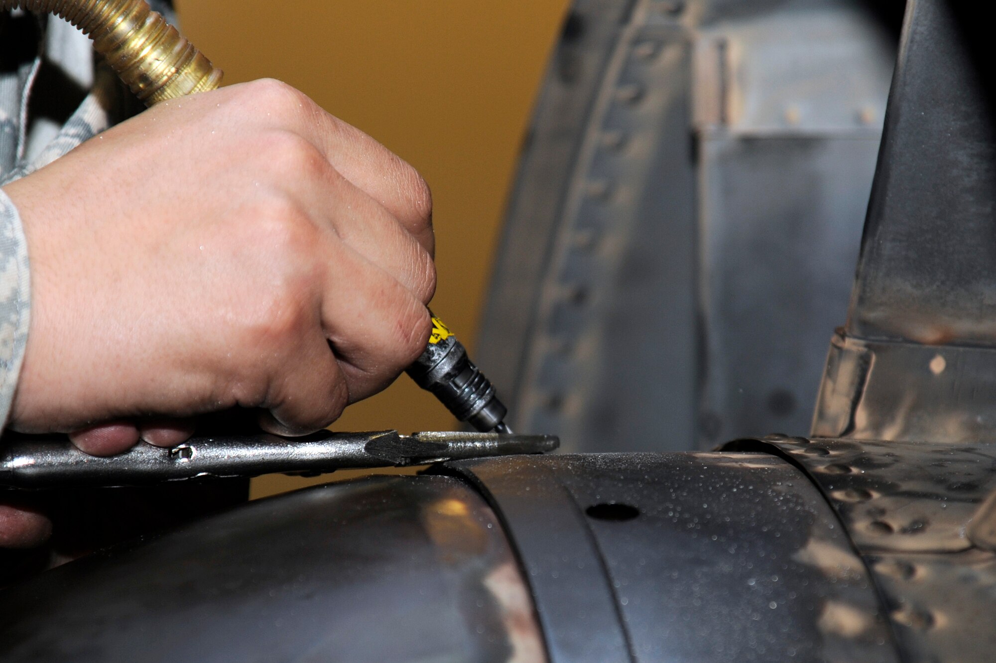 U.S. Air Force Airman 1st Class Alex Villanueva, 35th Maintenance Squadron aircraft metals technology apprentice, drills out a bolt on an F-16 Fighting Falcon F110-100 model engine at Misawa Air Base, Japan, March 27, 2012. It takes approximately six to seven Airmen to break down an engine from start to finish. (U.S. Air Force photo by Tech. Sgt. Marie Brown/Released)
