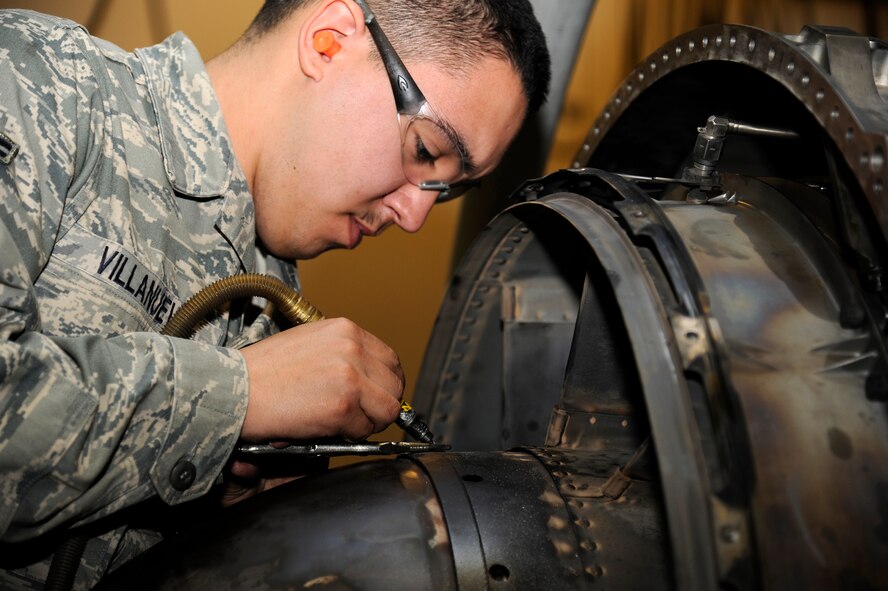 U.S. Air Force Airman 1st Class Alex Villanueva, 35th Maintenance Squadron aircraft metals technology apprentice, drills out a bolt on an F-16 Fighting Falcon F110-100 model engine at Misawa Air Base, Japan, March 27, 2012. It takes anywhere from one and a half to three weeks to break down and rebuild an engine from start to finish. (U.S. Air Force photo by Tech. Sgt. Marie Brown/Released)
