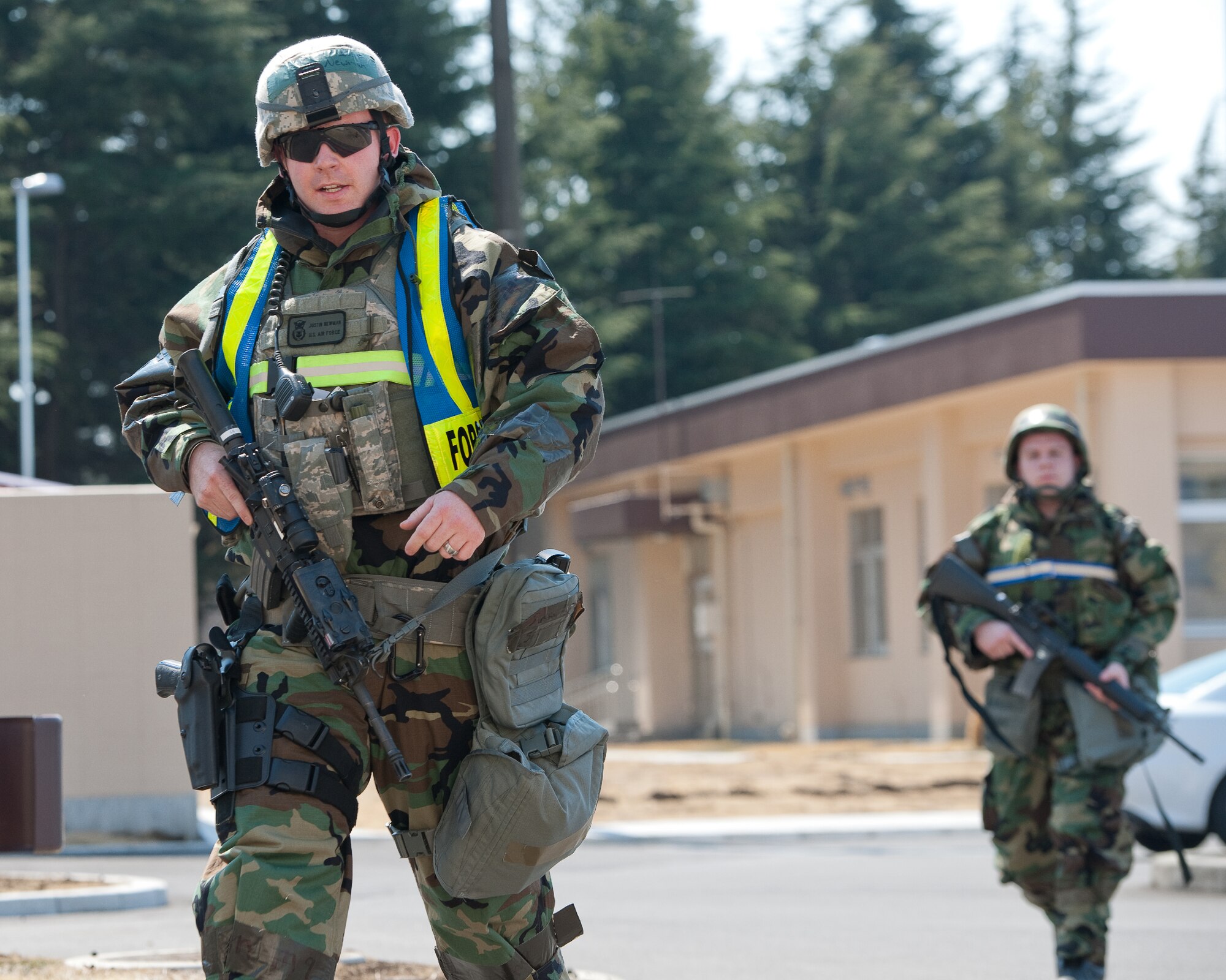 YOKOTA AIR BASE, Japan -- Senior Airman Justin Newman (left), 374th Security Forces Squadron patrolmen, and Senior Airman Trevor Port (right), 374th SFS augmentee, report a simulated mortar attack at Yokota Air Base, Japan, March 27, 2012. Airmen at Yokota participate in exercises to maintain their operational readiness capabilities. (U.S. Air Force photo/Osakabe Yasuo)
