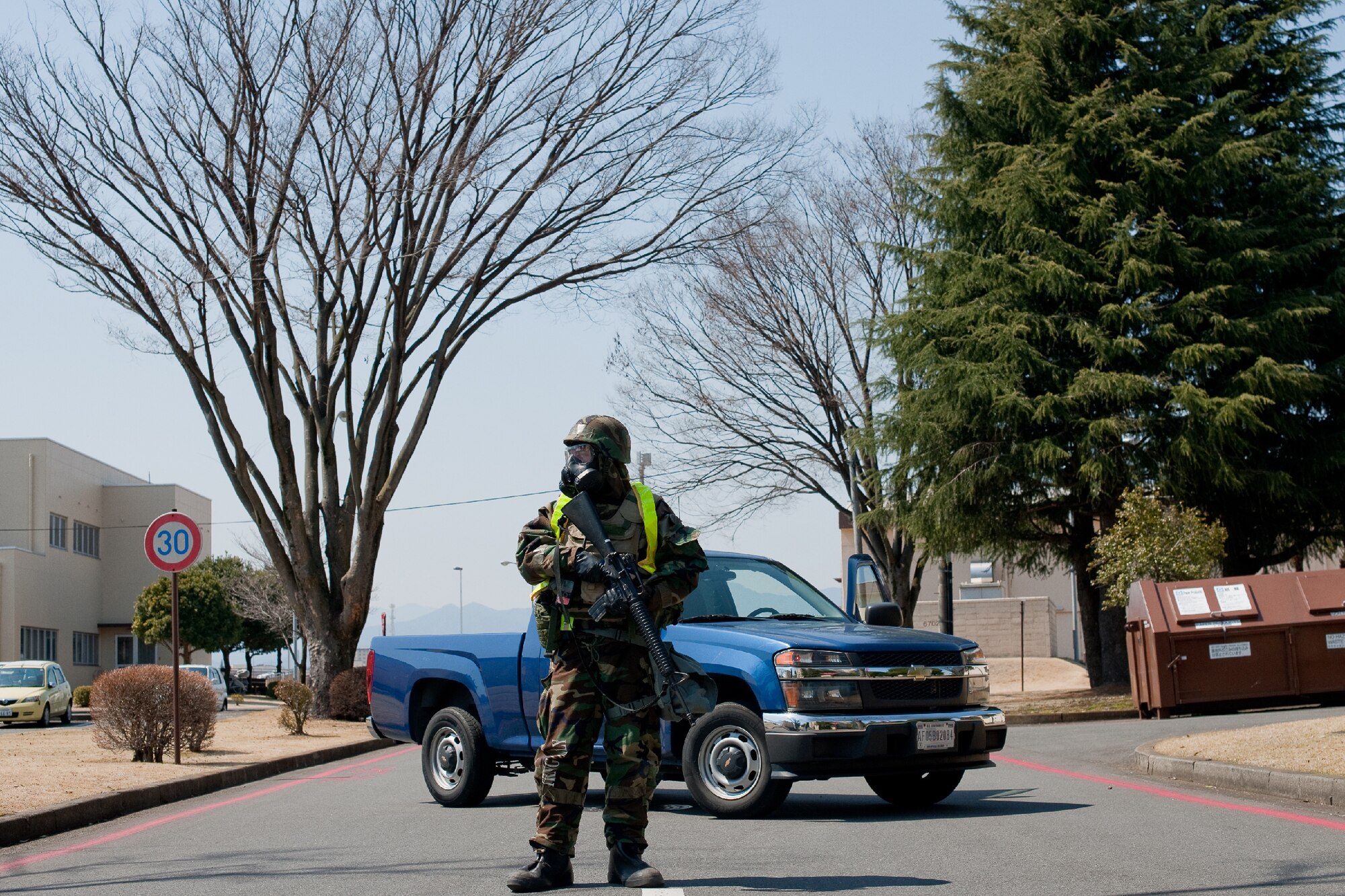 YOKOTA AIR BASE, Japan -- Airman 1st Class Phillip Cuendent, 374th Security Forces Squadron augmentee, directs traffic during a simulated mortar attack at Yokota Air Base, Japan, March 27, 2012. Yokota is participating in an exercise to maintain operational readiness capabilities.  (U.S. Air Force photo/Osakabe Yasuo) 