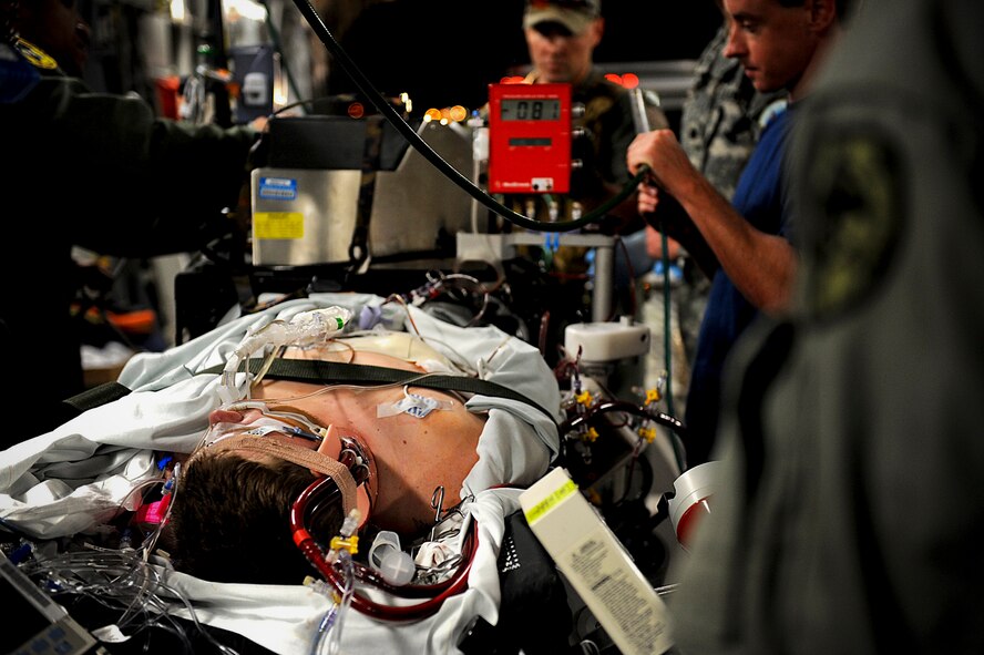 A U.S. Marine suffering from pneumonia at Kadena Air Base, Japan is transported to Hawaii for further treatment, March 26, 2012. Although the team of medical staff serves in different branches of service, they work together as a team toward a common goal; getting the patient what he needs.  (U.S. Air Force photo by Airman 1st Class Brooke P. Beers/Released)