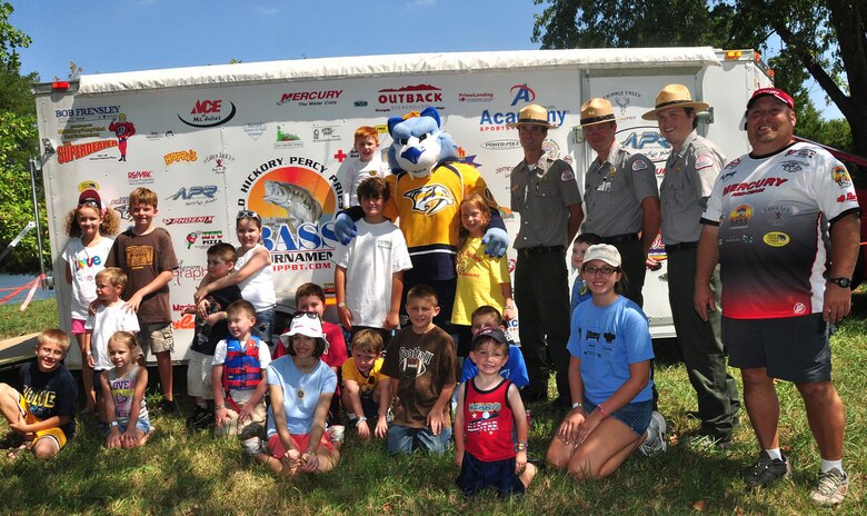 Old Hickory Lake park rangers Noel Smith (left), Charlie Leath (middle), and Trey Church (right) pose with an Old Hickory Percy Priest Bass Tournament Club official, Nashville Predators mascot Gnash, and the children that participated in the Kid's Fishing and Family Fan Day Tournament. 