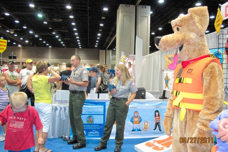 LOUISVILLE, Ky. -- Lake Barkley Park Ranger Charlotte Stenger and U.S. Army Corps of Engineers water safety mascot Bobber the Water Safety Dog speak about inflatable life jackets to Kentucky State Fair visitors here, Aug. 27, 2011.
