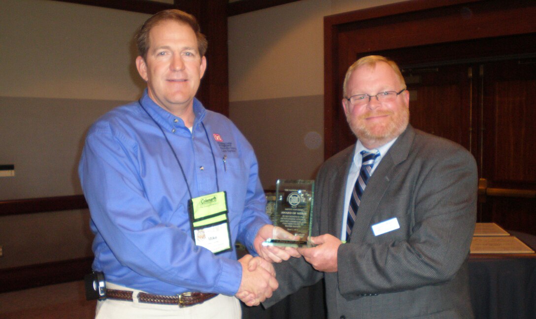 SAN DIEGO -- U.S. Army Corps of Engineers Lake Barkley natural resource manager Michael Looney (left), receives the Award of Merit from the National Water Safety Congress Region 3 Vice President Ernest Lentz March 5, 2012, during the National Water Safety Congress during the International Boating and Water Safety Summit.