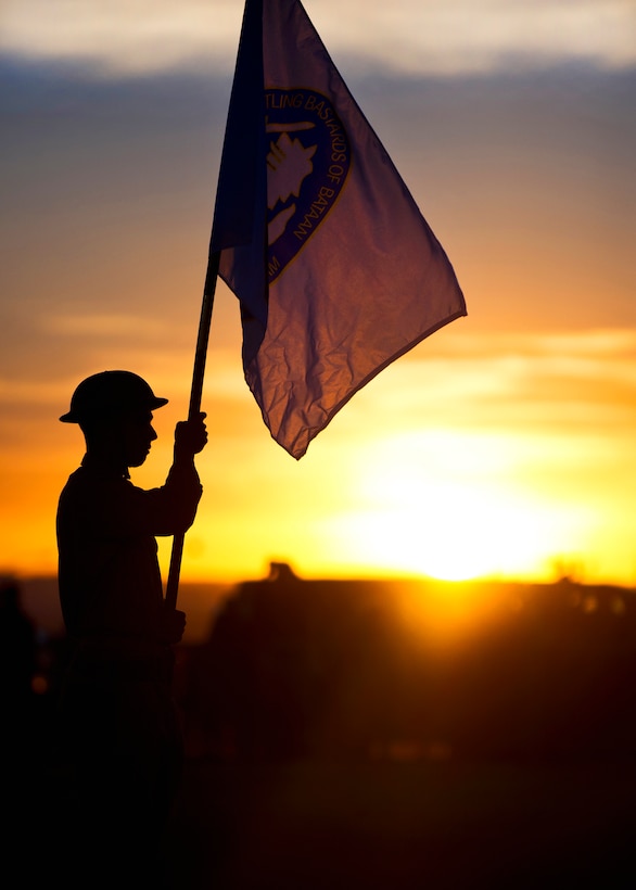 A soldier posts the flag of the Battling Bastards of Bataan at the opening ceremony of the 23rd Annual Bataan Memorial Death March on White Sands Missile Range, N.M., March 25, 2012.