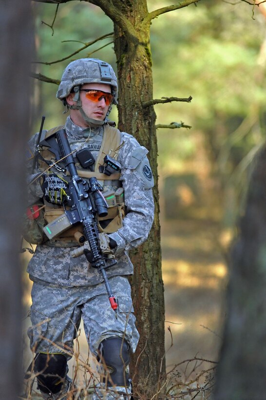 U.S. Army Cpl. Anthony Saviano scans the terrain while on patrol during ...