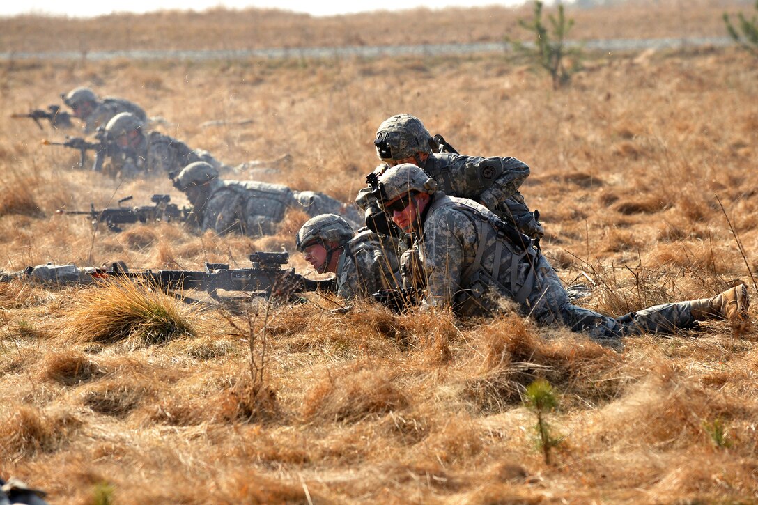 U.S. soldiers react to an attack in open terrain during a situational training exercise at Grafenwoehr Training Area, Joint Multinational Training Command in Vilseck, Germany, March 22, 2012.