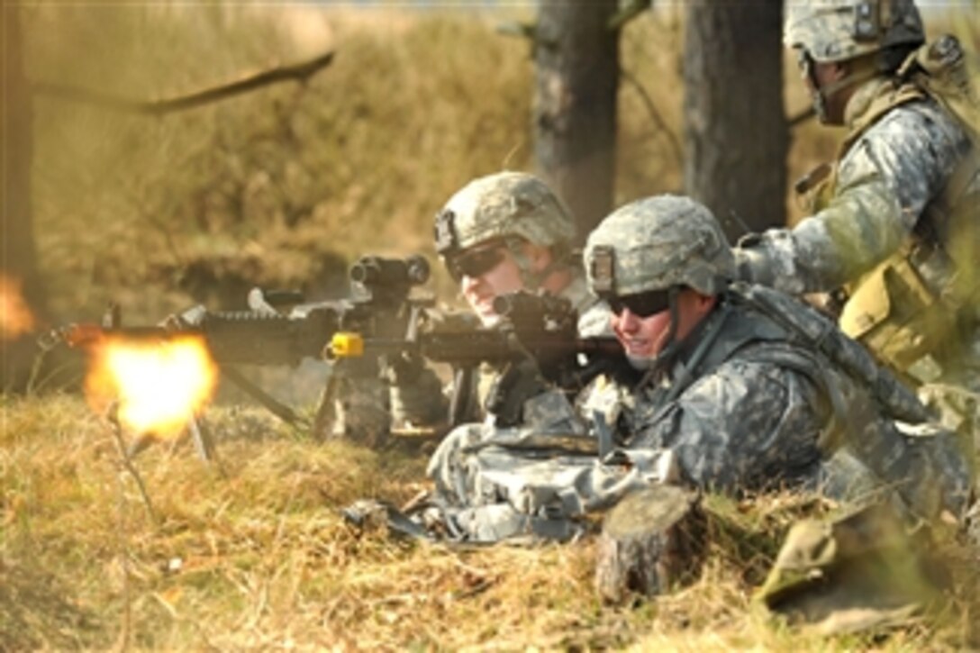 U.S. Army Pvt. Ryan Slade (left) fires an M240 machine gun as Spc. Cody Branam fires his M4 carbine during a situational training exercise at the Grafenwoehr Training Area in Grafenwoehr, Germany, on March 22, 2012.  Both soldiers are assigned to India Company, 3rd Squadron, 2nd Cavalry Regiment.  