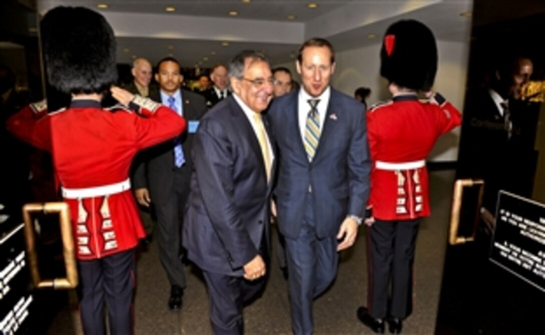 U.S. Defense Secretary Leon E. Panetta, left, walks with Canadian Defense Minister Peter MacKay as they proceed to trilateral meetings with defense ministers from Canada and Mexico in Ottawa, Ontario, March 27, 2012.