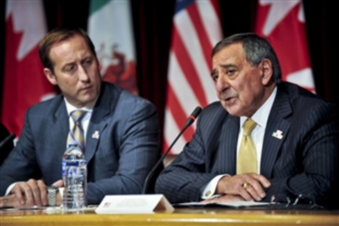 U.S. Defense Secretary Leon E. Panetta answers questions from reporters as Canadian Defense Minister Peter MacKay looks on after a trilateral meeting in Ottawa, Ontario, March 27, 2012.